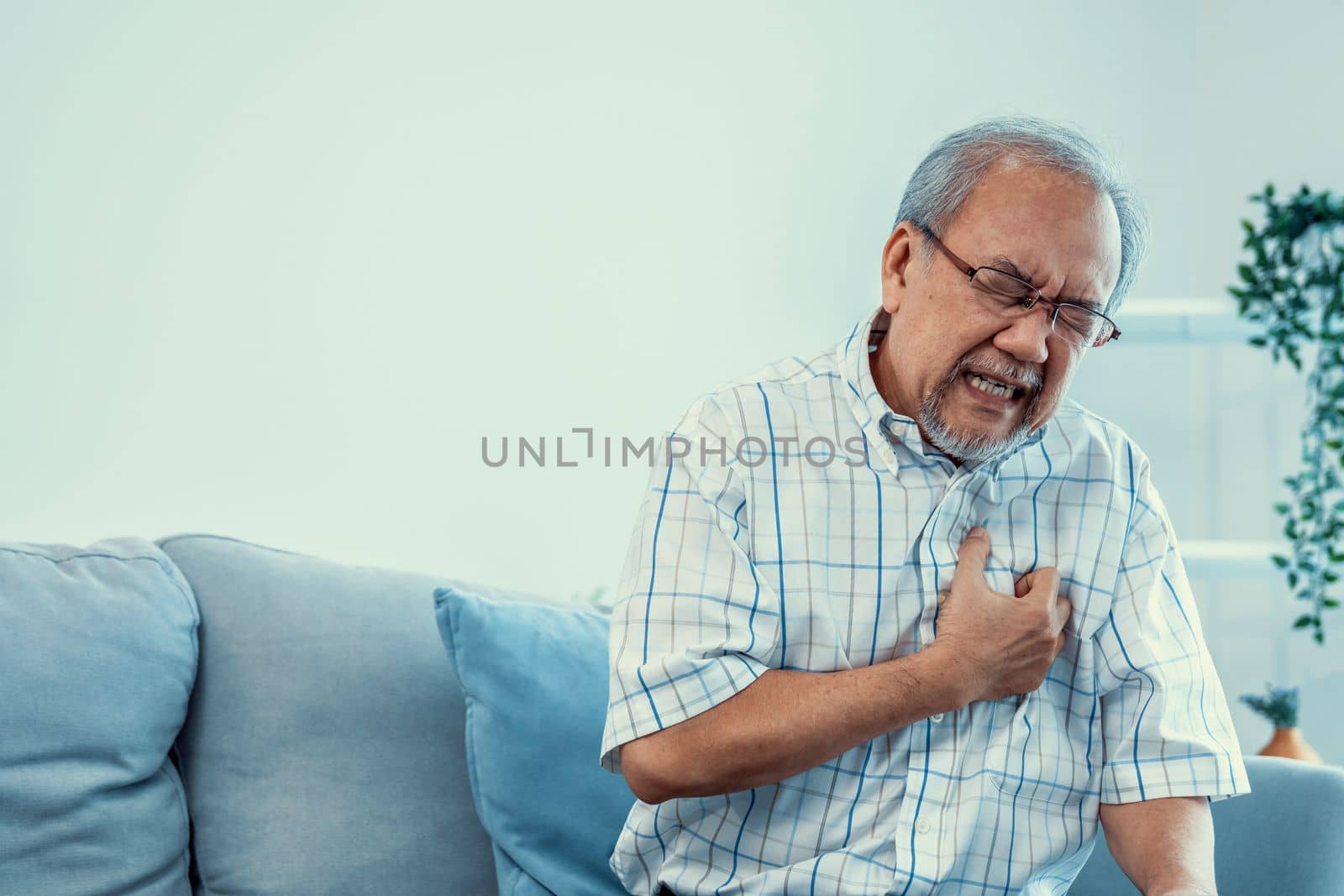 An agonizing senior man suffering from chest pain or heart attack. by biancoblue