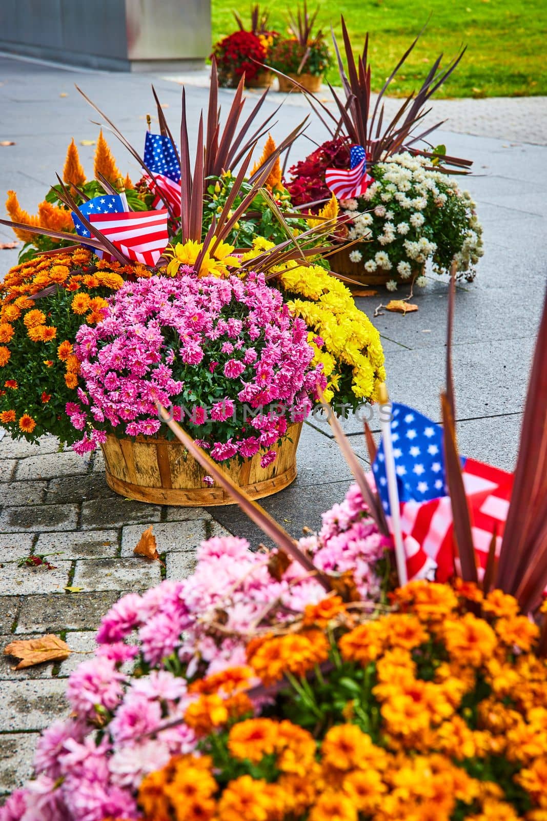 Image of Detail of American flowerpots with oranges, pinks, yellows, and American Flags
