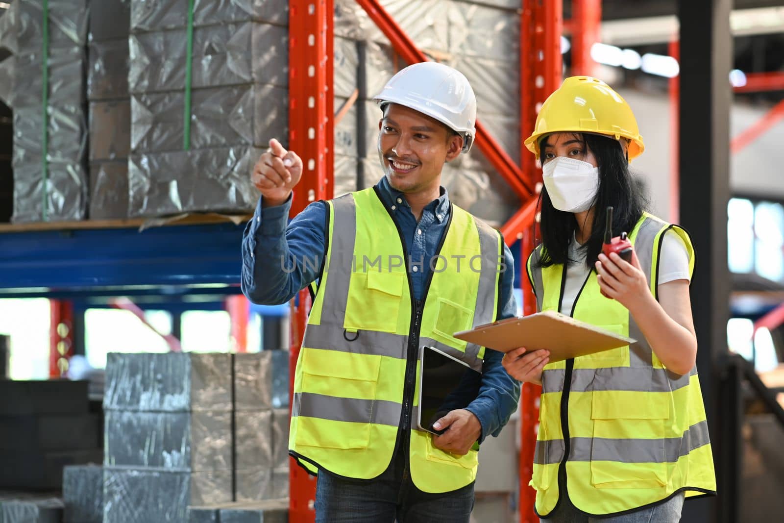 Storehouse workers are checking stock and inventory in retail warehouse. Business factory industry concept.