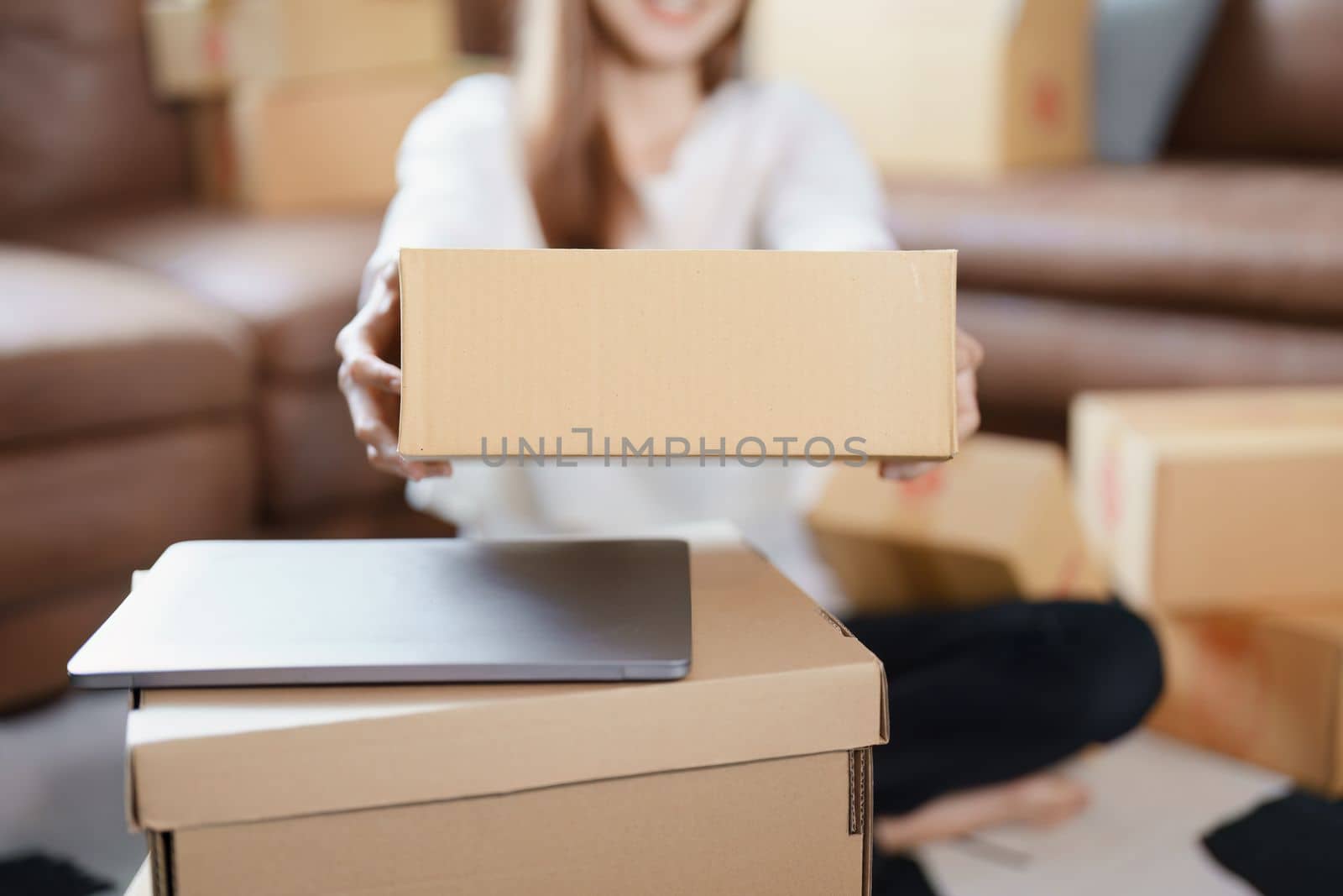 Starting small business entrepreneur of independent Asian female online seller packing products to send to customers and SME delivery concept by Manastrong