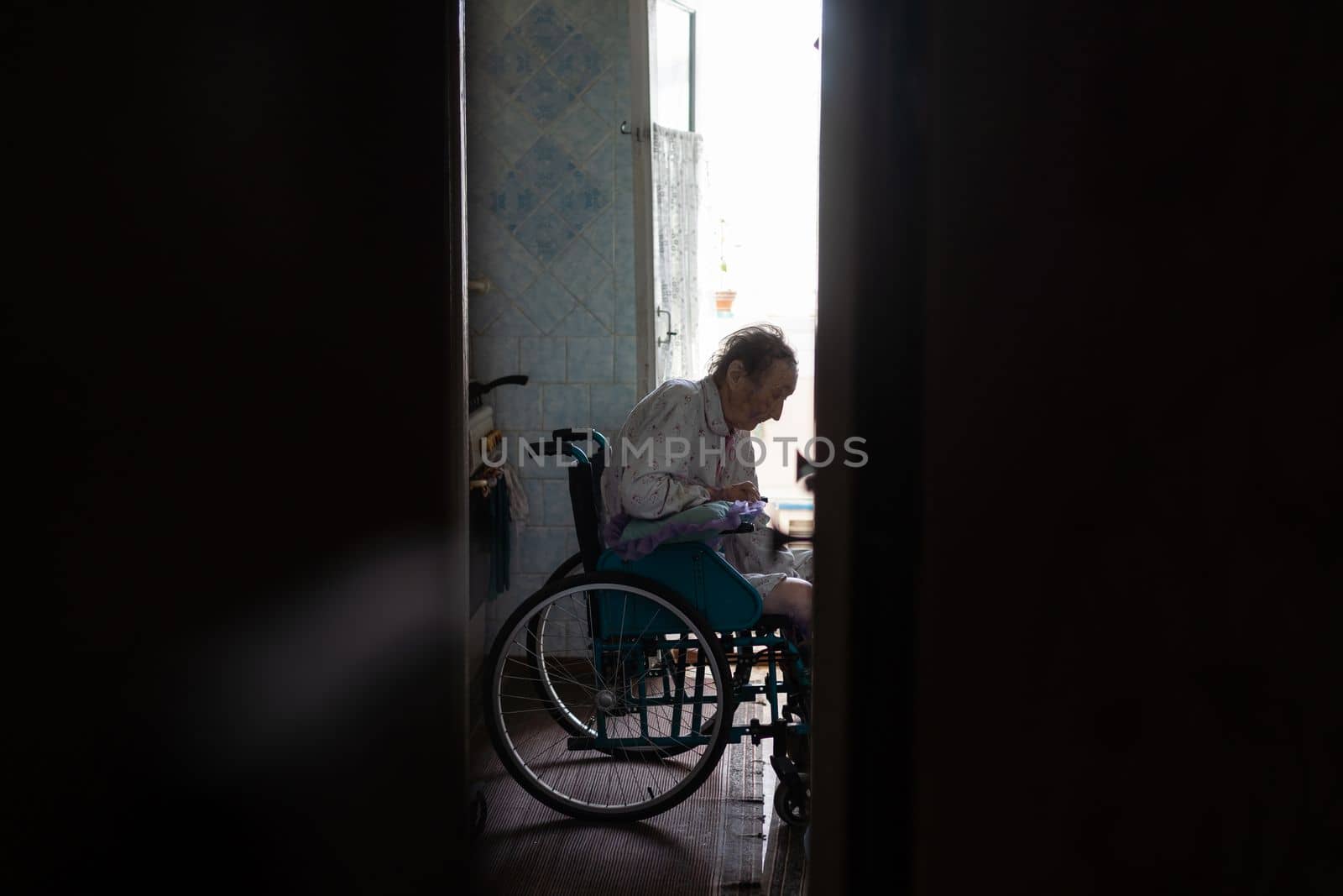 very old woman in a wheelchair by Andelov13