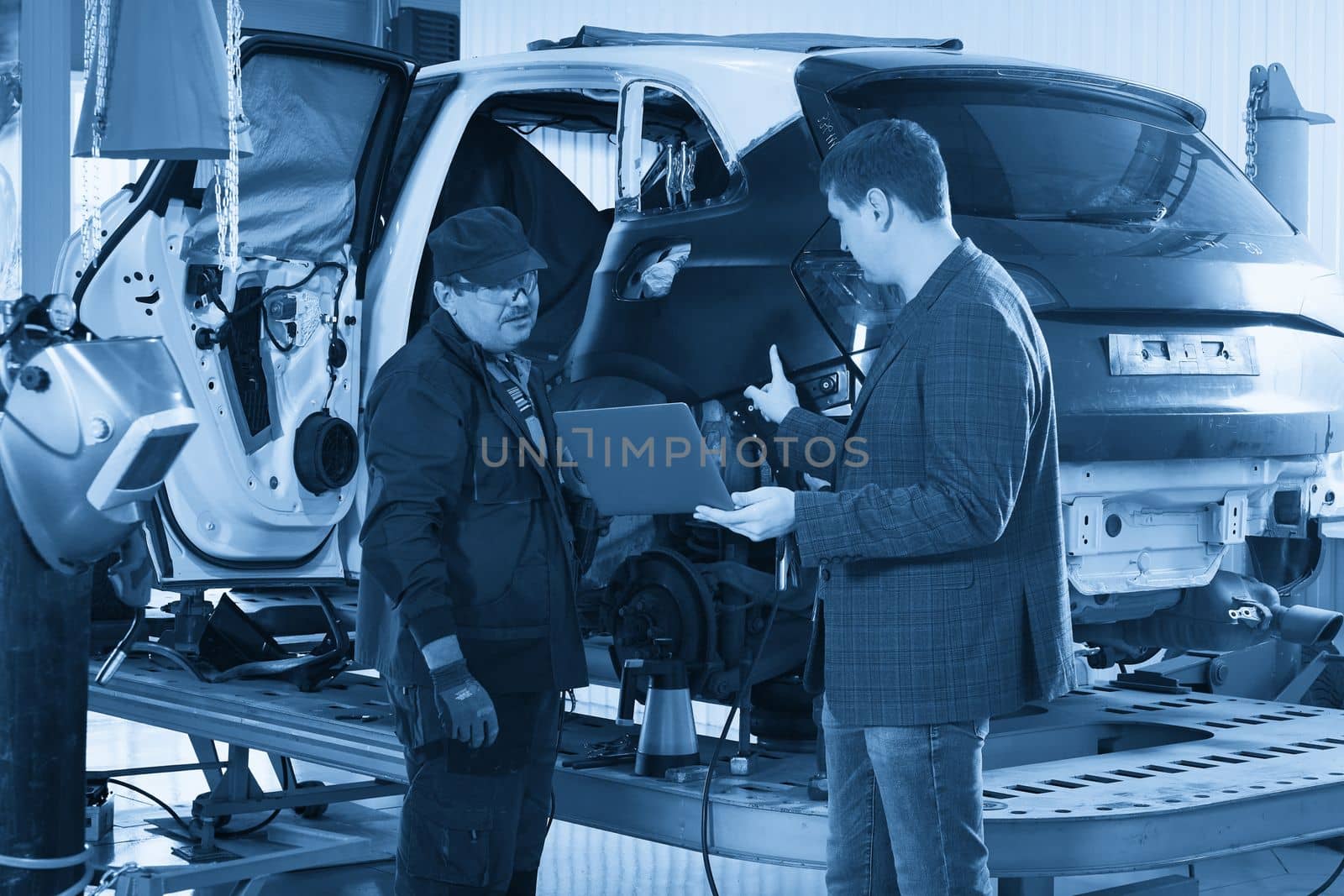 Manager In Auto Repair Service with mechanic on background