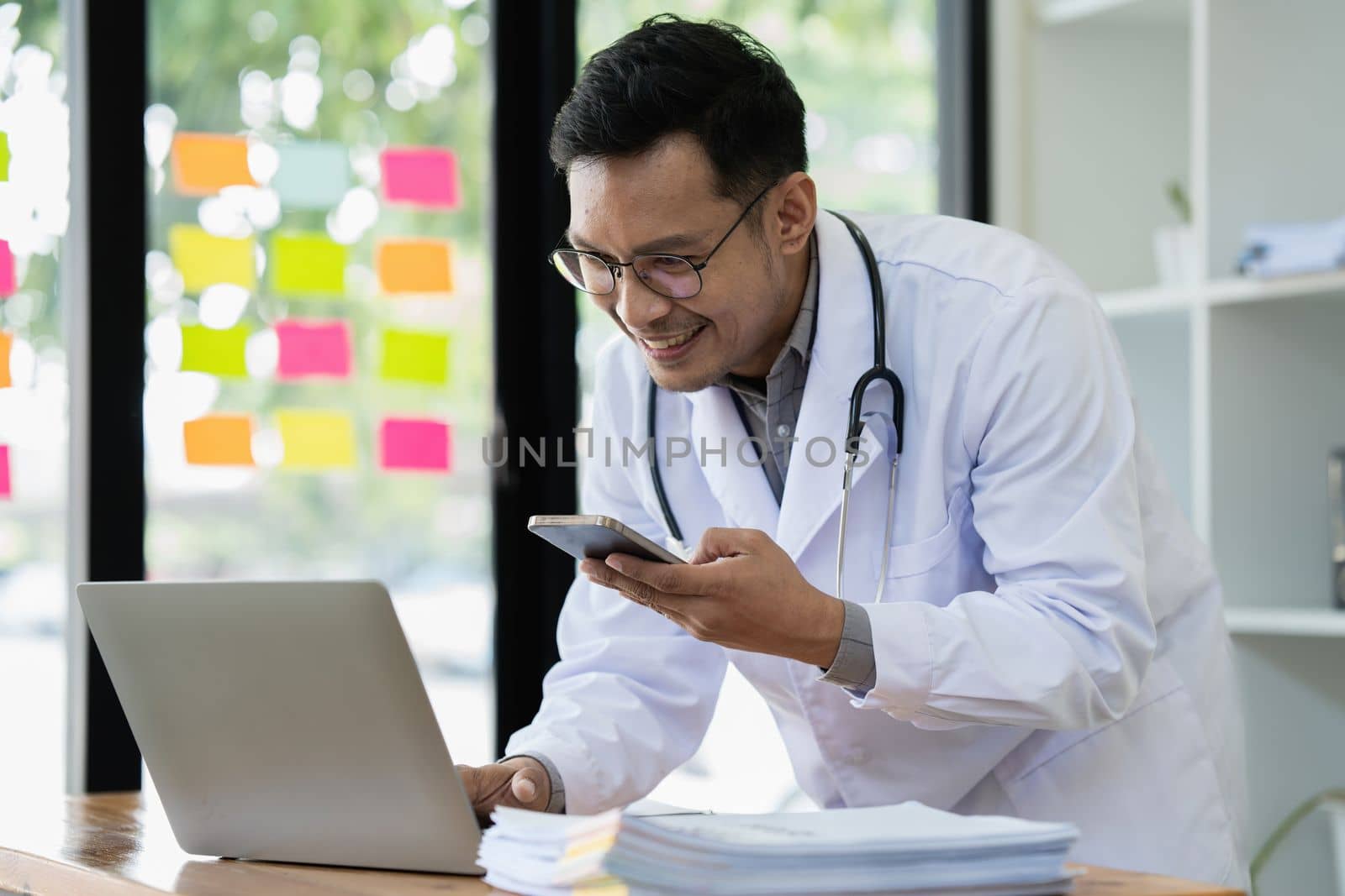 Doctor working with laptop at clinic. Medical technology and network concept.