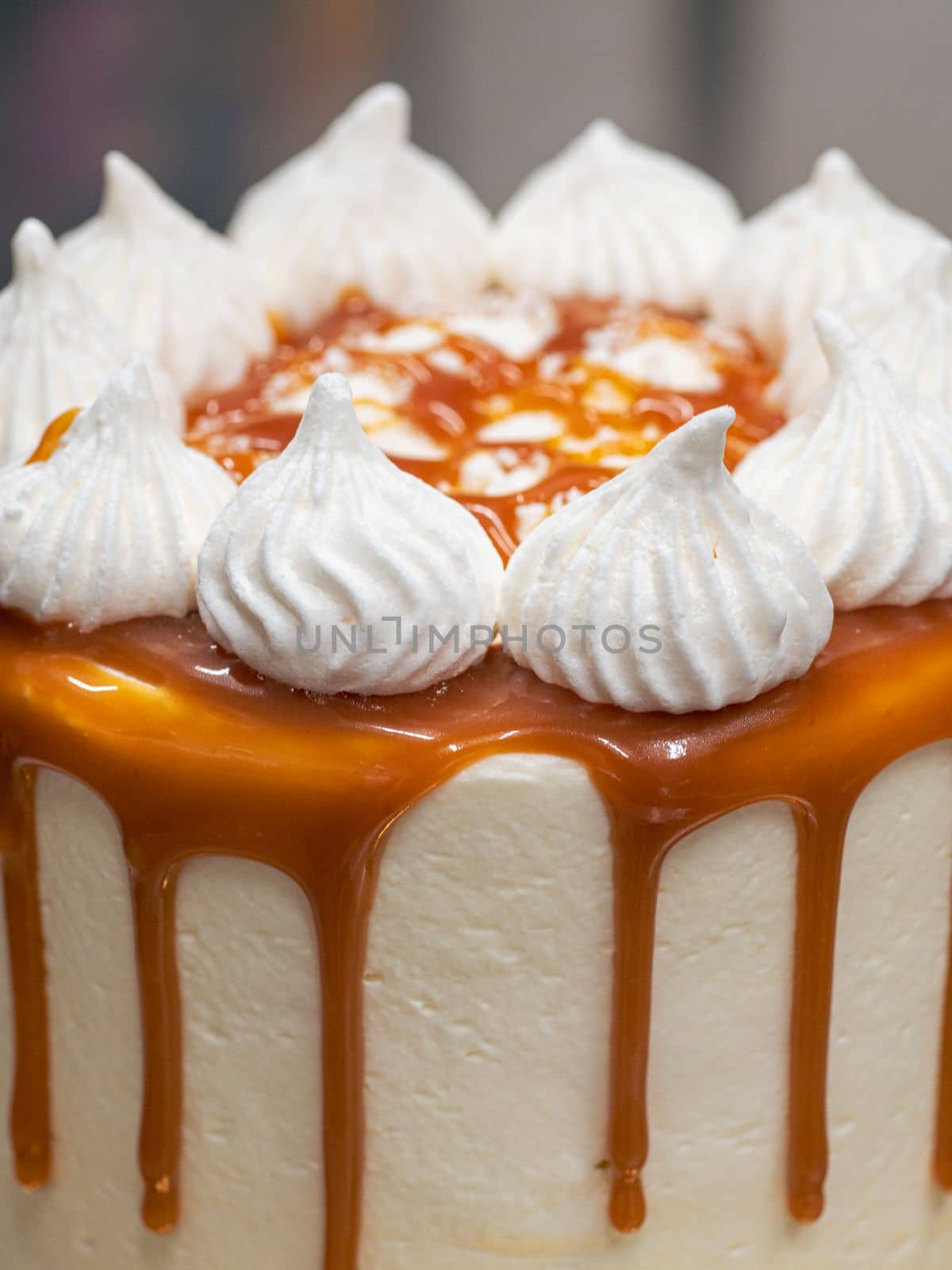 professional baker decorating a chocolate and cream cake with salty caramel