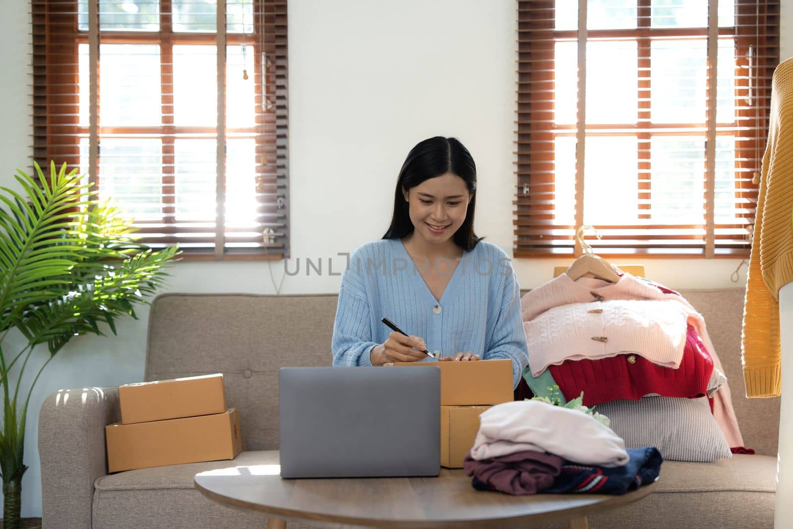 Startup small business entrepreneur SME, asian woman packing box. Portrait of young Asian small business owner in home office, online sell marketing delivery