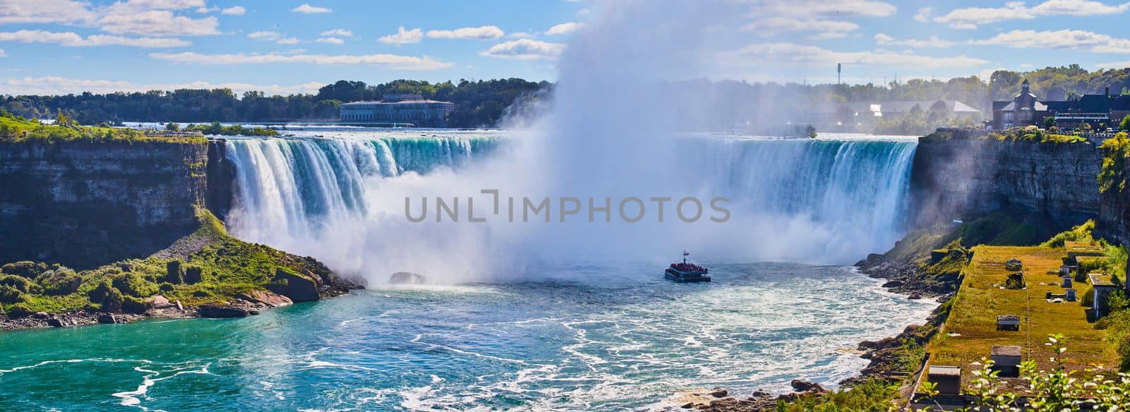 Image of Eye level view of Niagara Falls Horseshoe Falls from Canada with mist surrounded tourist ship