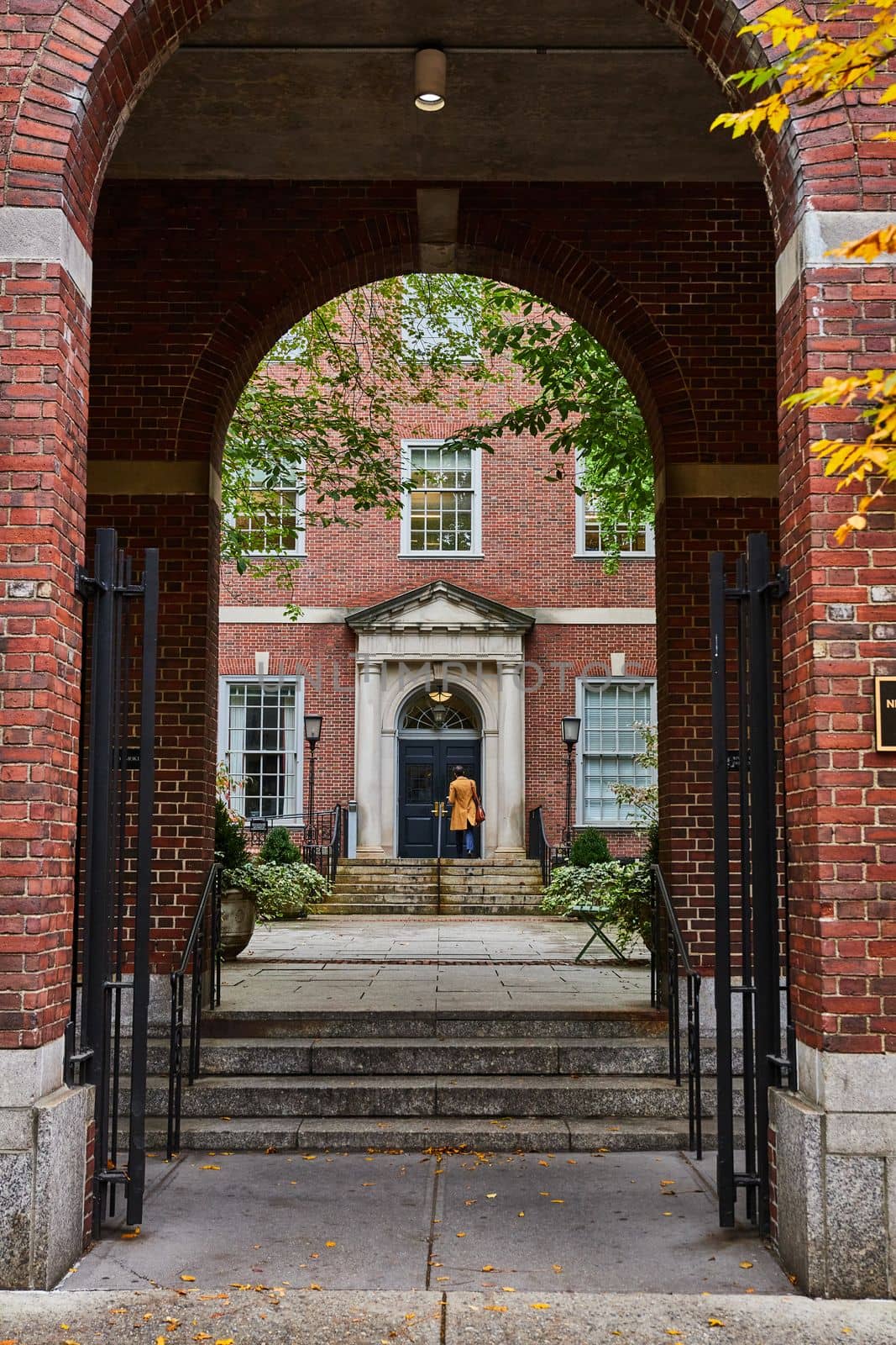 Image of View through brick arches of law student in courtyard of New York City