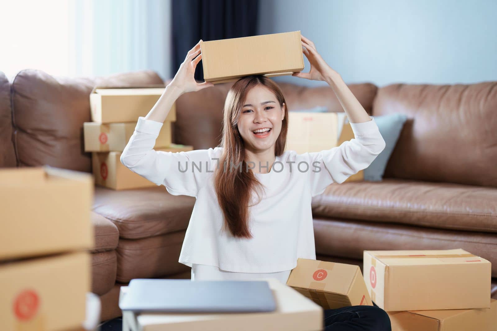 Starting small business entrepreneur of independent Asian female online seller packing products to send to customers and SME delivery concept.