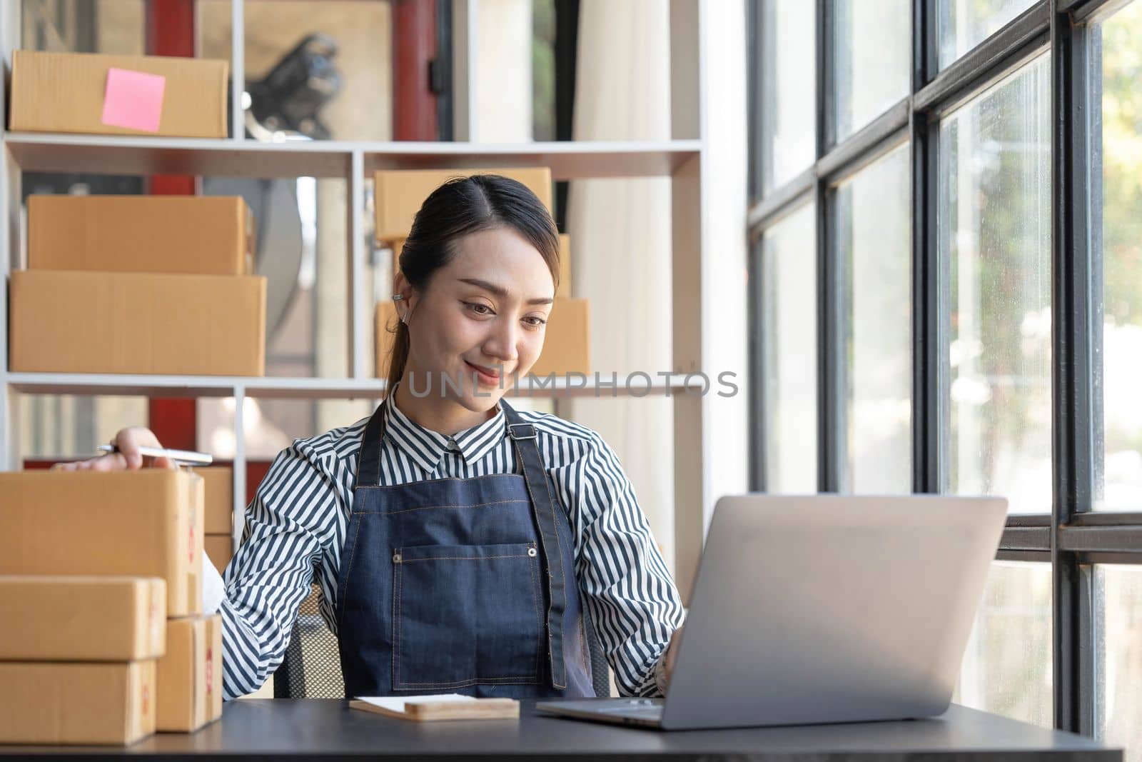Starting small businesses SME owners female entrepreneurs check online orders to prepare to pack the boxes, sell to customers, sme business ideas online...