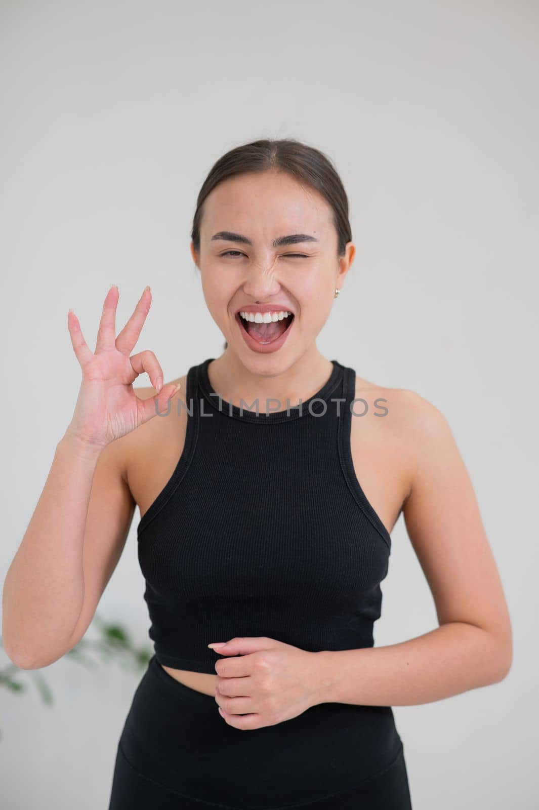 Portrait of beautiful asian woman showing ok sign