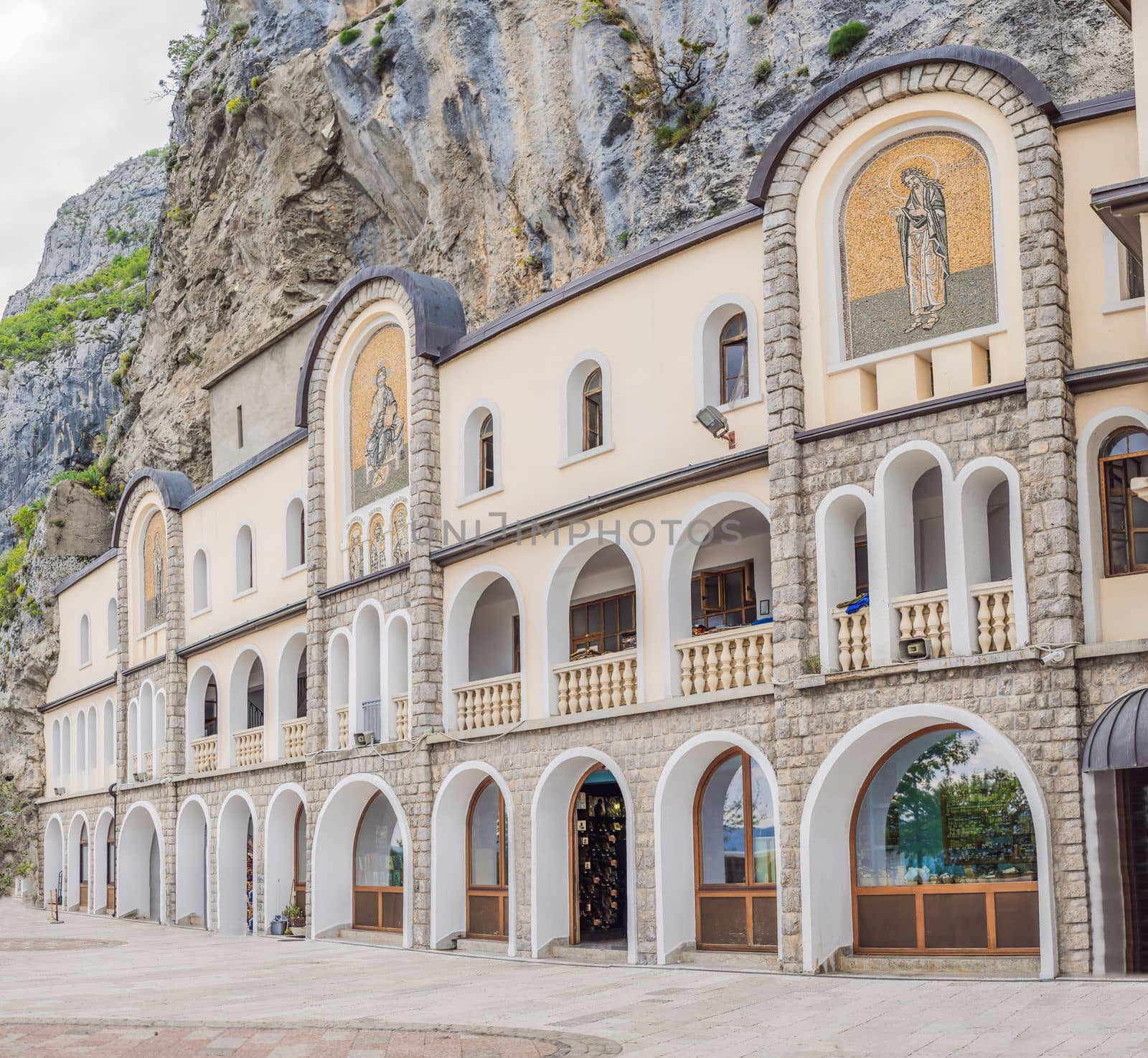 Monastery of Ostrog, Serbian Orthodox Church situated against a vertical background, high up in the large rock of Ostroska Greda, Montenegro. Dedicated to Saint Basil of Ostrog by galitskaya