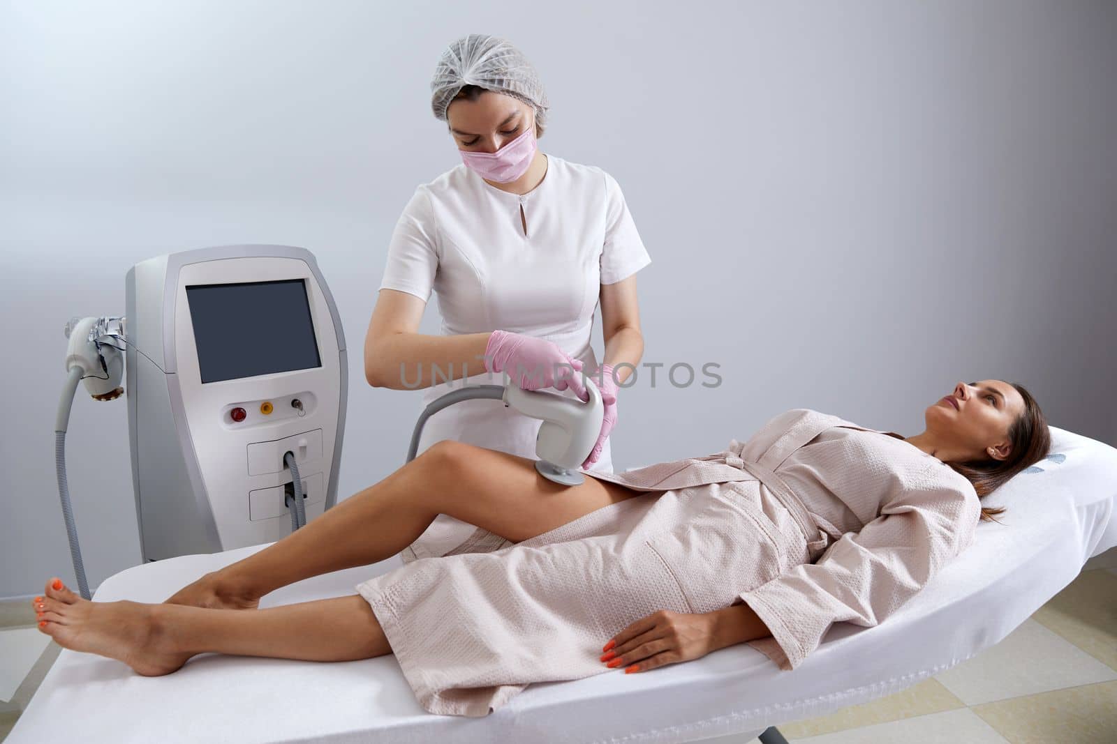 Woman Having Laser Treatment On Thigh. Ultrasound cavitation body contouring treatment. Anti cellulite treatment