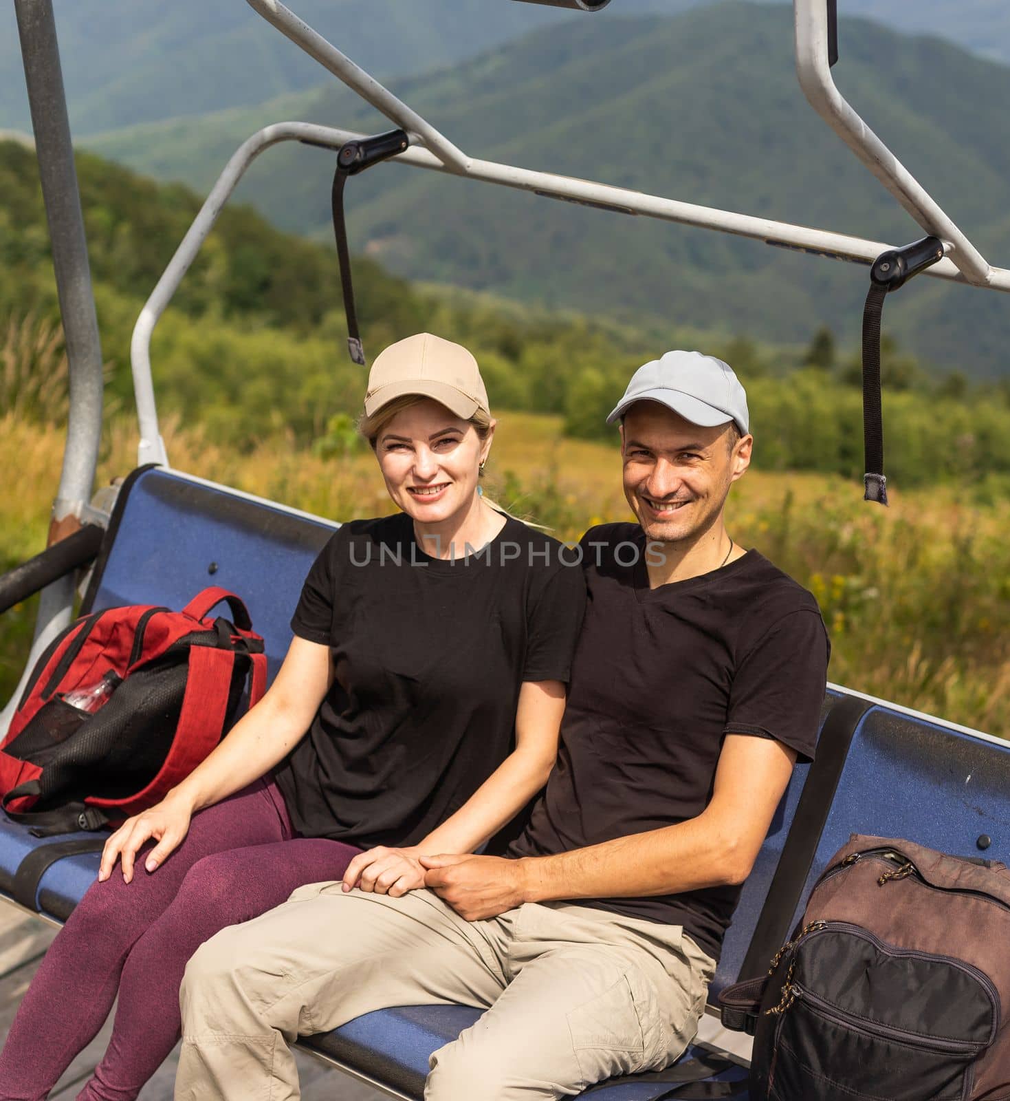 man and woman on the lift in the mountains