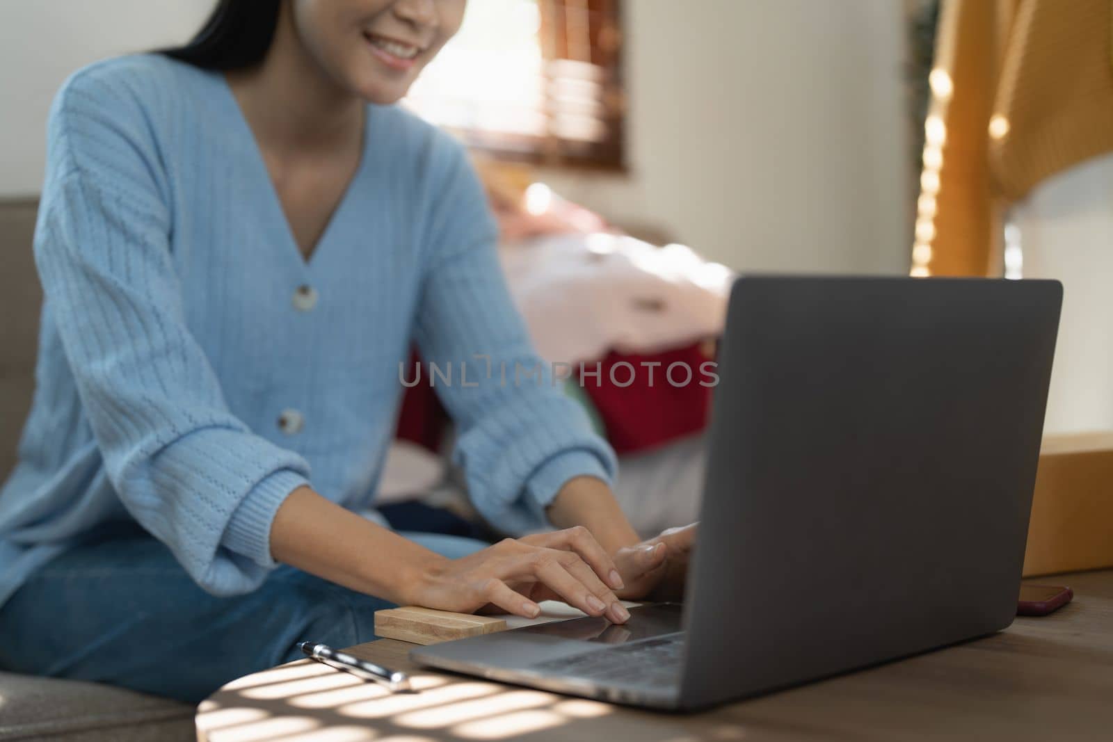 Young person using credit card and laptop computer. Online shopping, e-commerce concept.