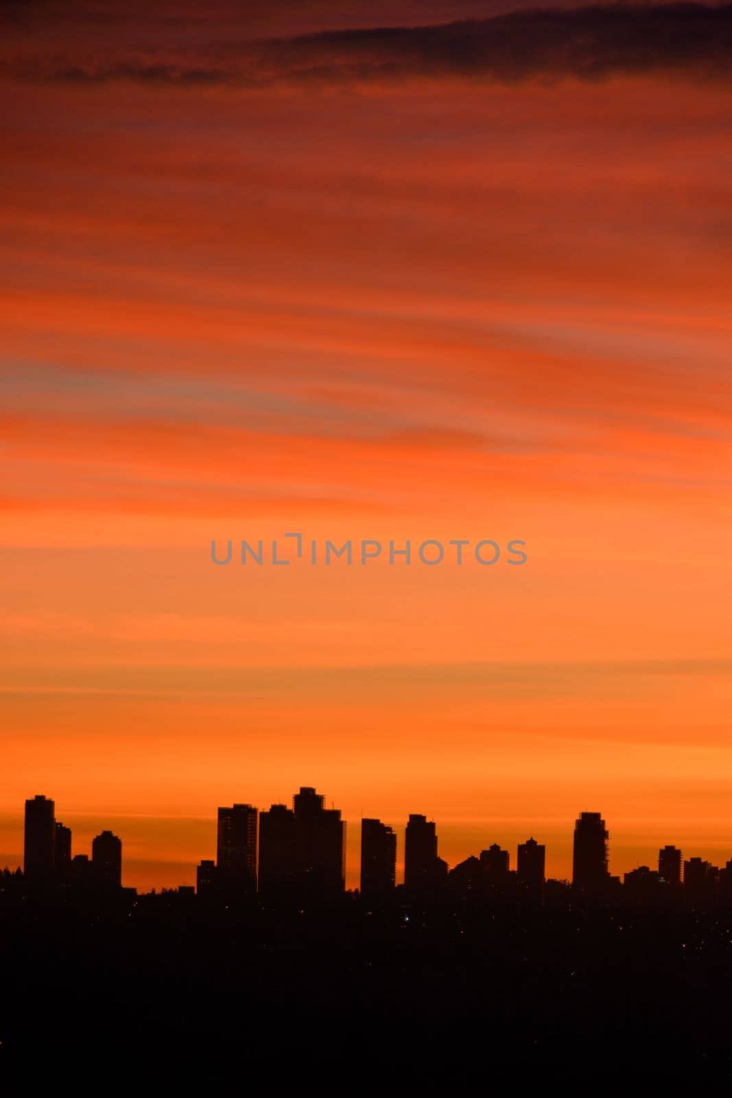 silhouette of residential buildings on sunset sky background.