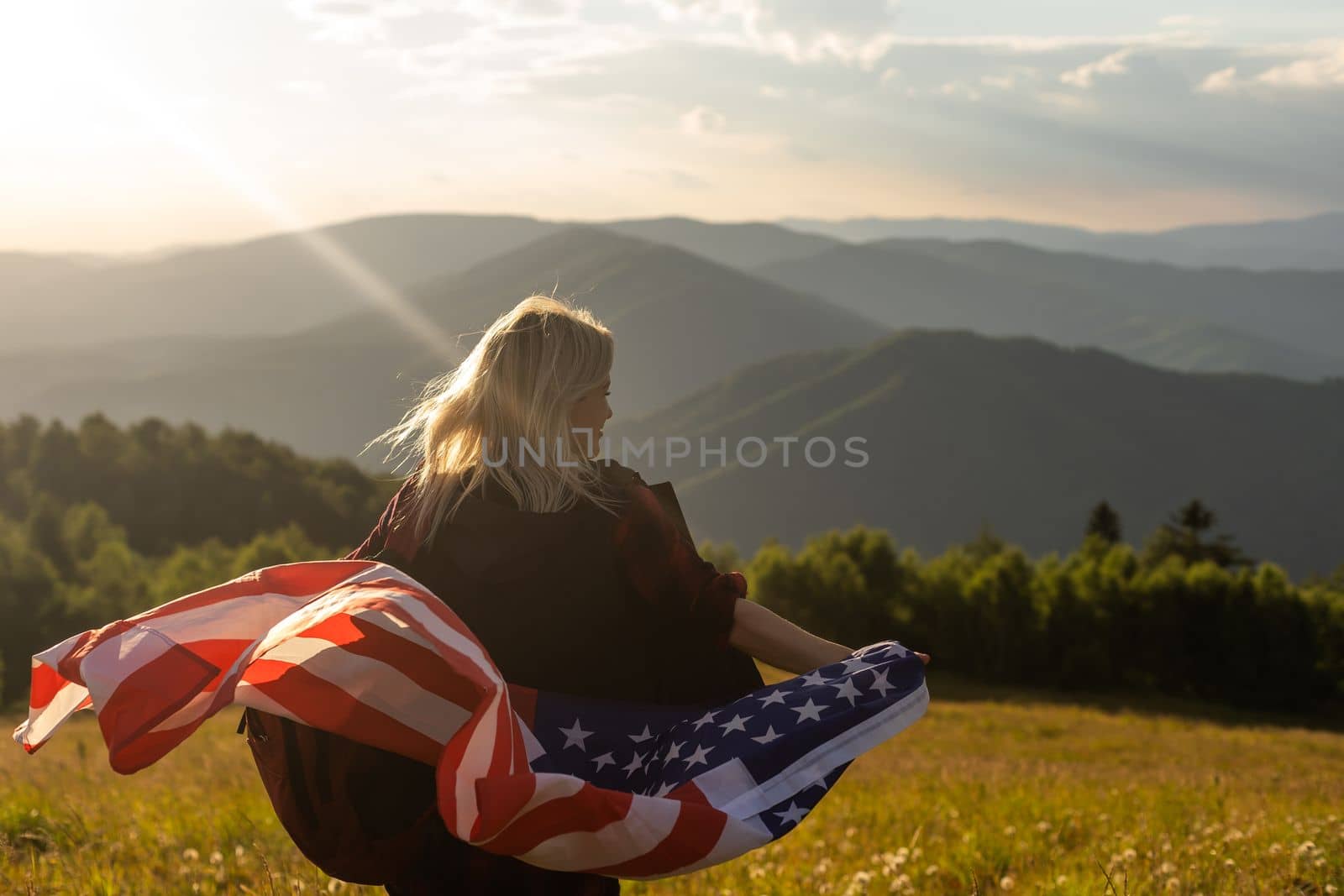 young beautiful woman holding USA flag. by Andelov13