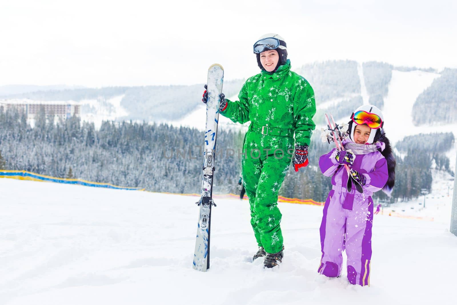 Ski, winter and fun - Family: mother and daughter enjoying winter vacations. by Andelov13