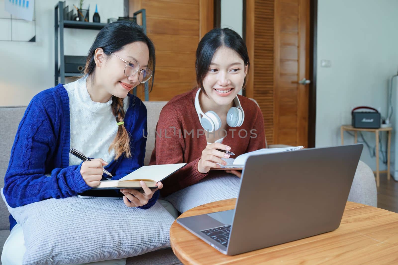 lgbtq, lgbt concept, homosexuality, portrait of two asian women posing happy together and loving each other while playing computer laptop with notebook for learning online.