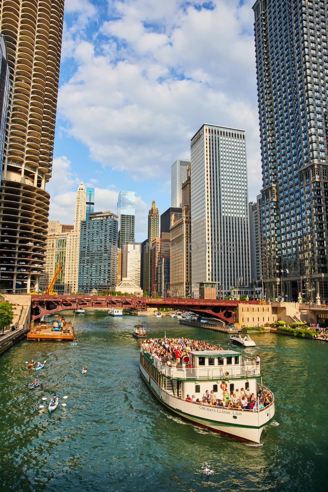 Image of Chicago ship canal lined with skyscrapers and large tourist ship passing through