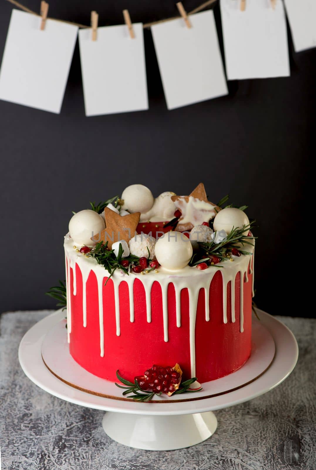 Homemade Christmas cake on rustic wooden stand and holiday decoration