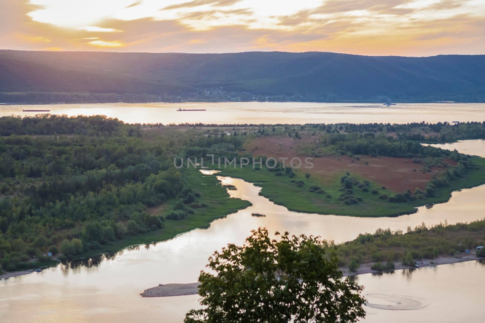 sunset on the Volga river. Natural landscape. reflection, blue sky and yellow sunlight. landscape during sunset.