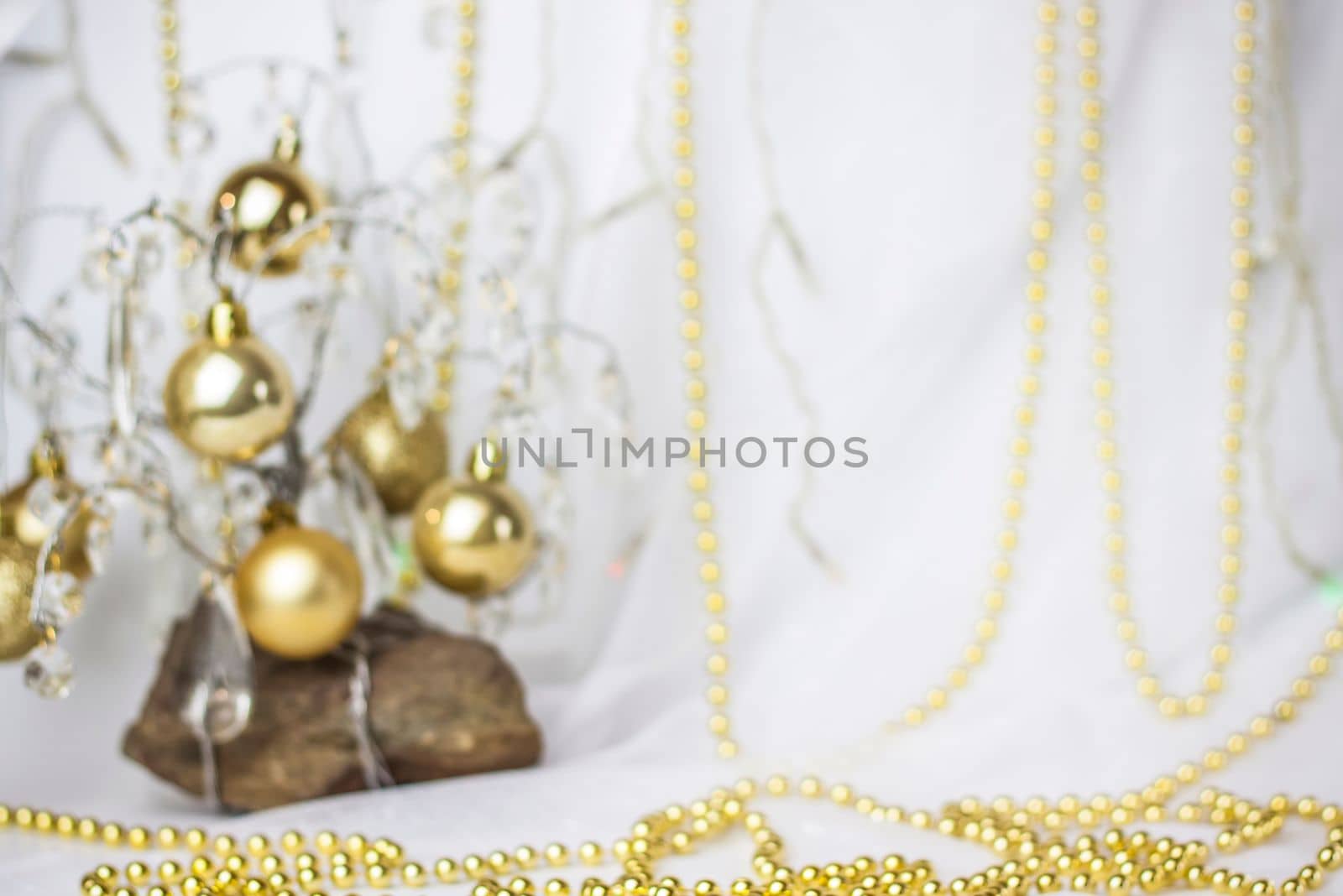 Christmas background with a Christmas tree on which small golden balls hang. Selective focus, a picture for the background. the concept of Christmas and New Year.