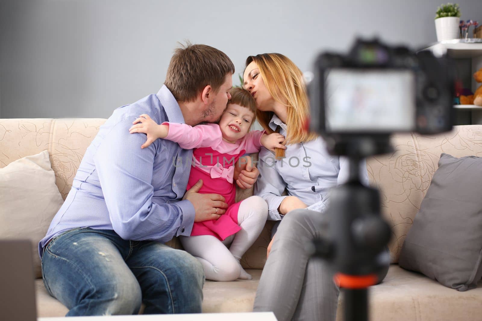 Family with capricious child take photo on camera by kuprevich