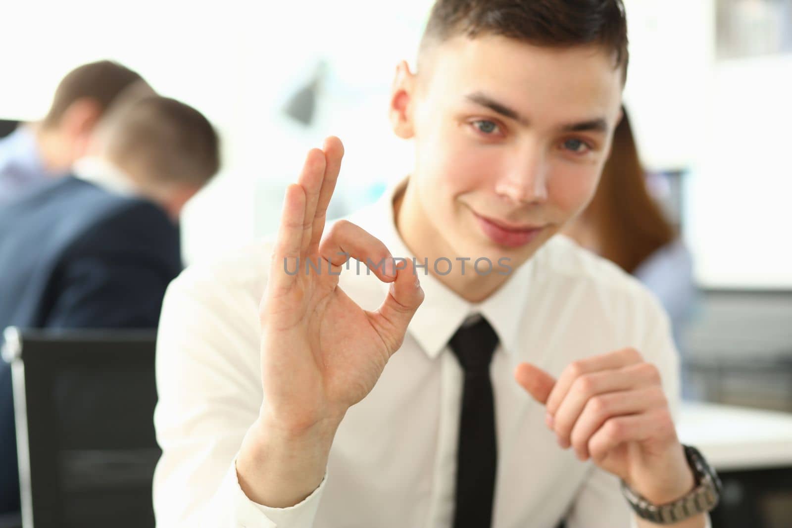 Portrait of young business male student gesturing ok on learning. Business coaching for personal growth and a successful career