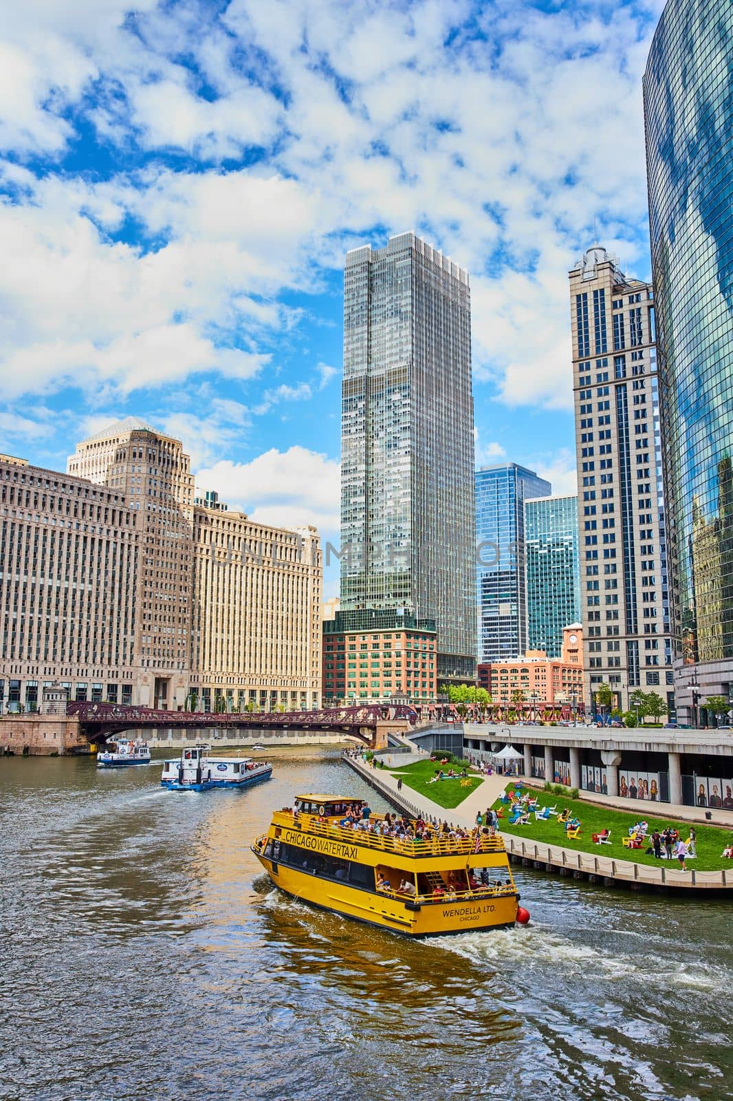 Image of Large tourist ship in Chicago canals by skyscrapers