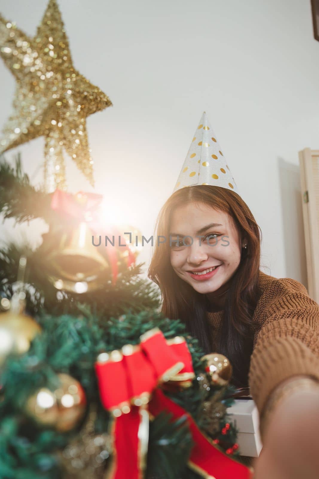 Cheerful lady surprised of the present after the opening in the gift box. Marry Christmas and Happy Holidays and New Year eve celebrating concept.