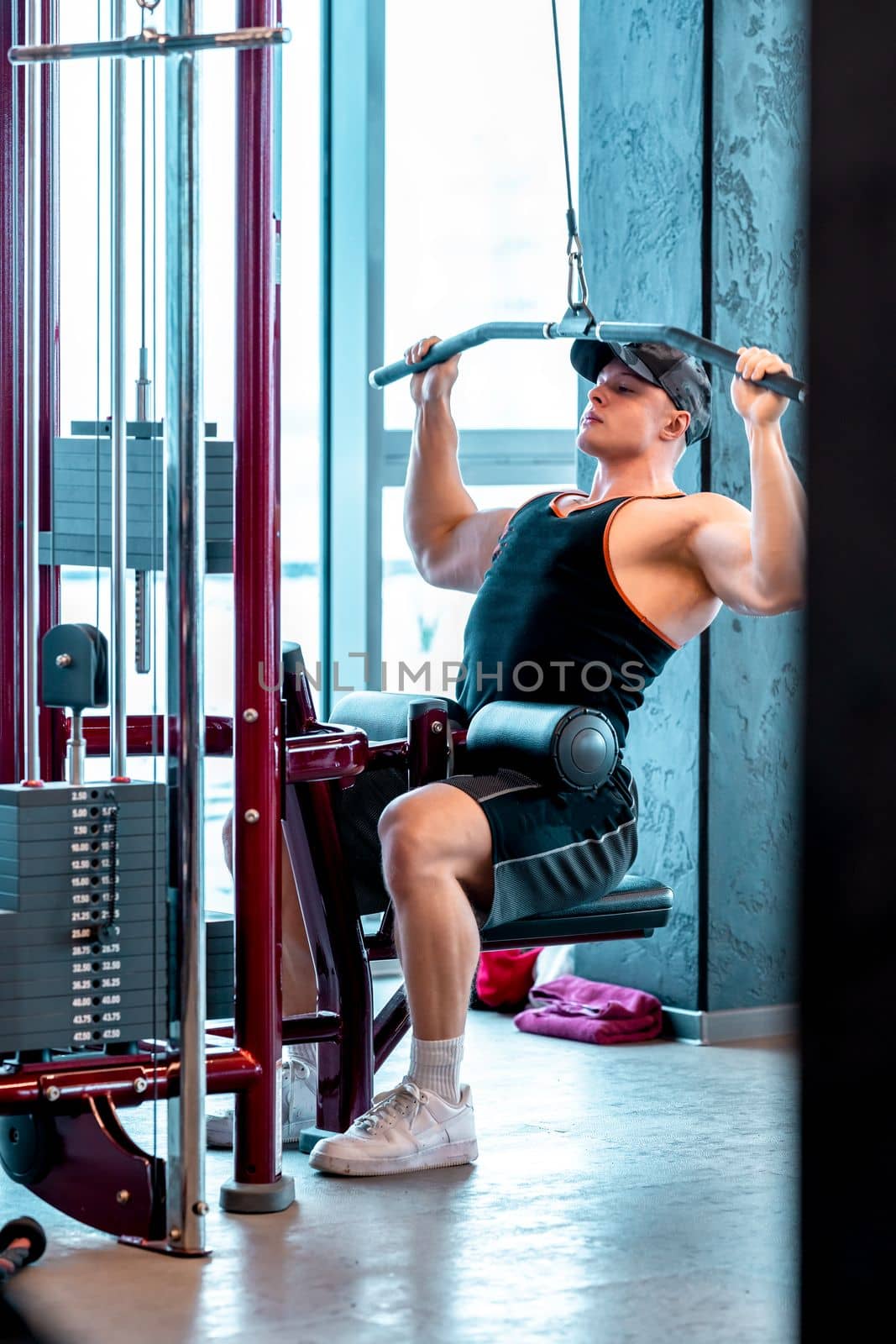 exercise of the back muscles by pulling the pulley on the strength machine. 