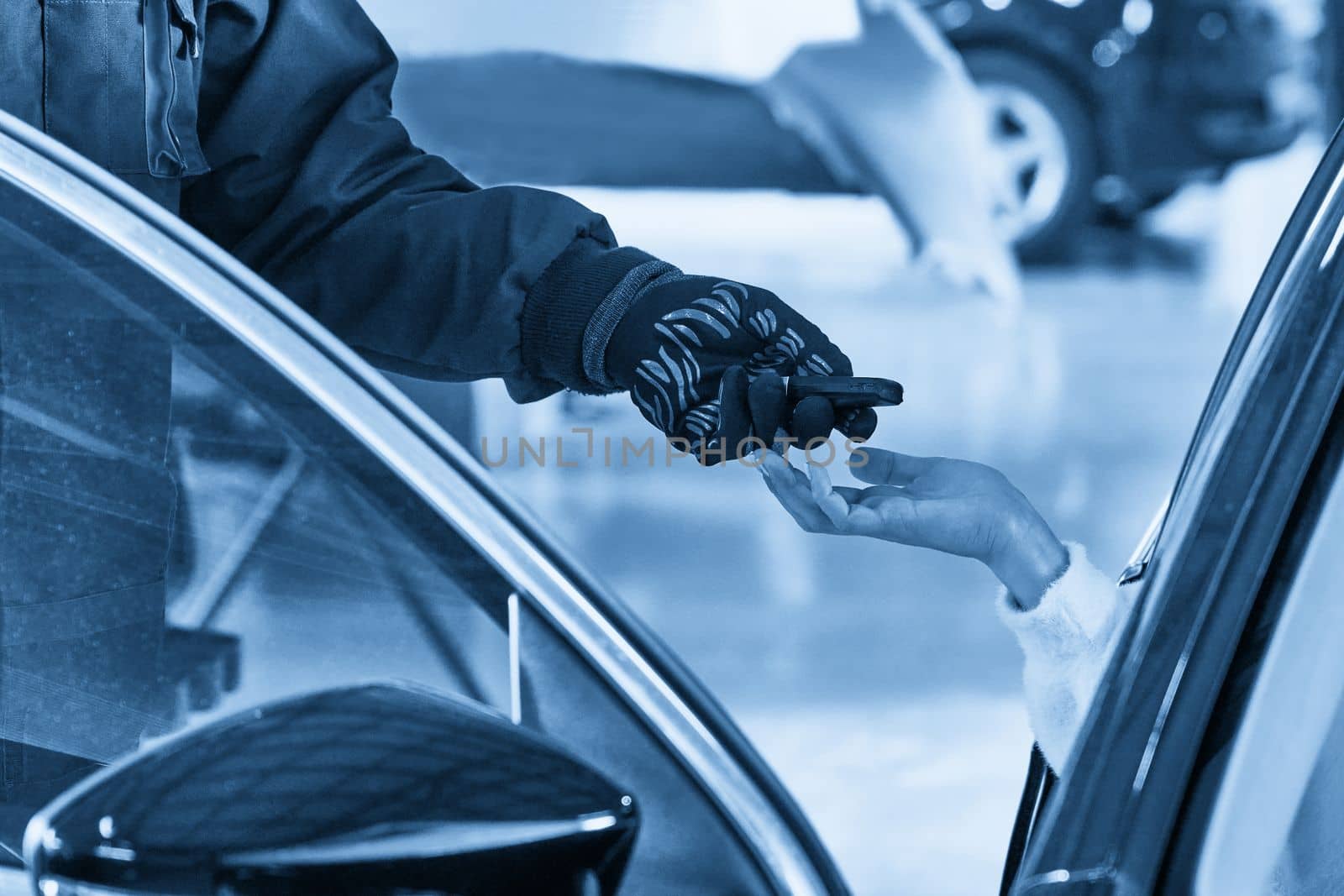 Professional Car Mechanic Giving Client Keys from her Repaired Car In Auto Repair Service