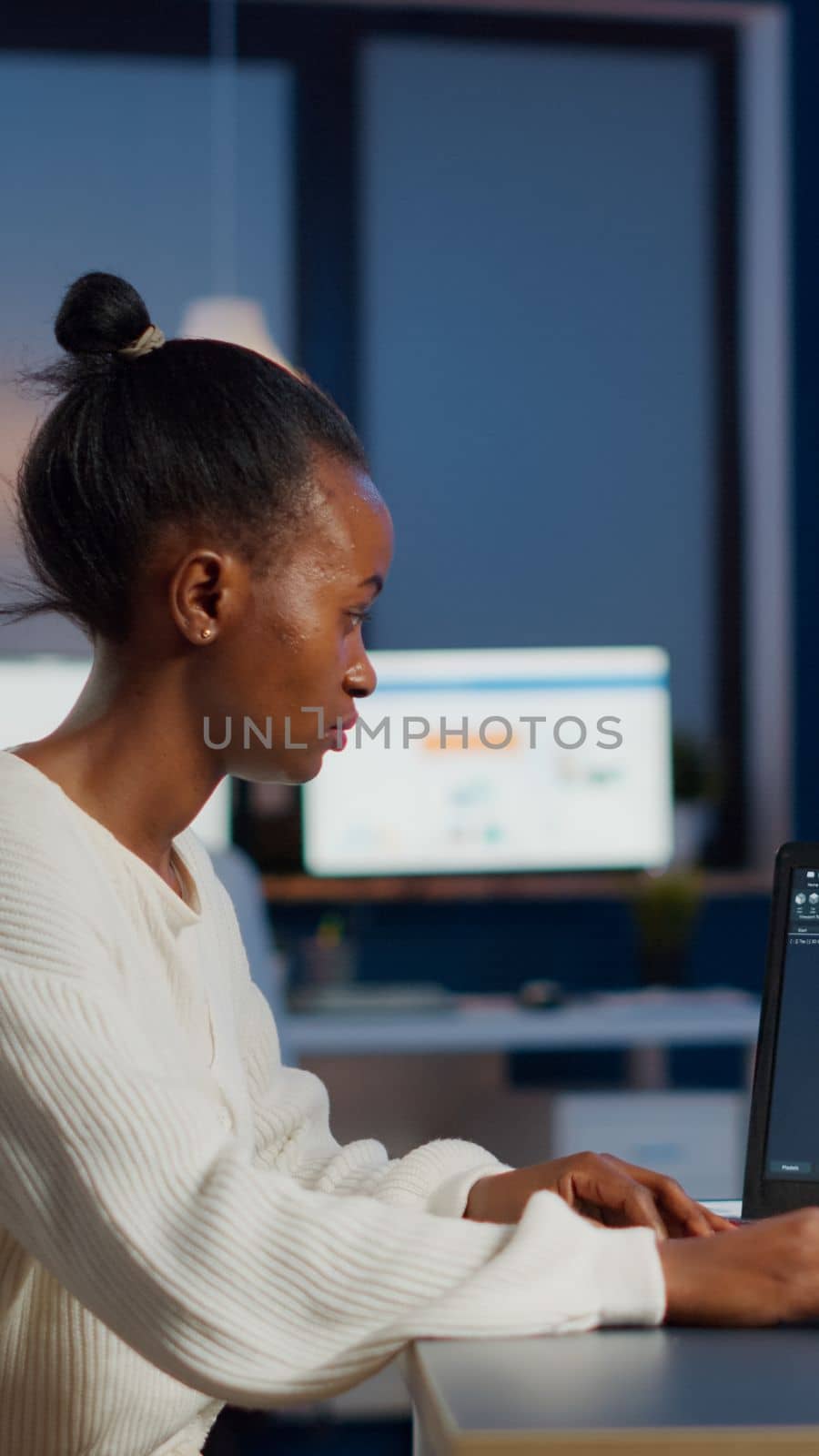 African woman engineer working in modern cad program with gear sitting at desk in start-up business office. Industrial employee studying prototype idea on laptop showing cad software on device display
