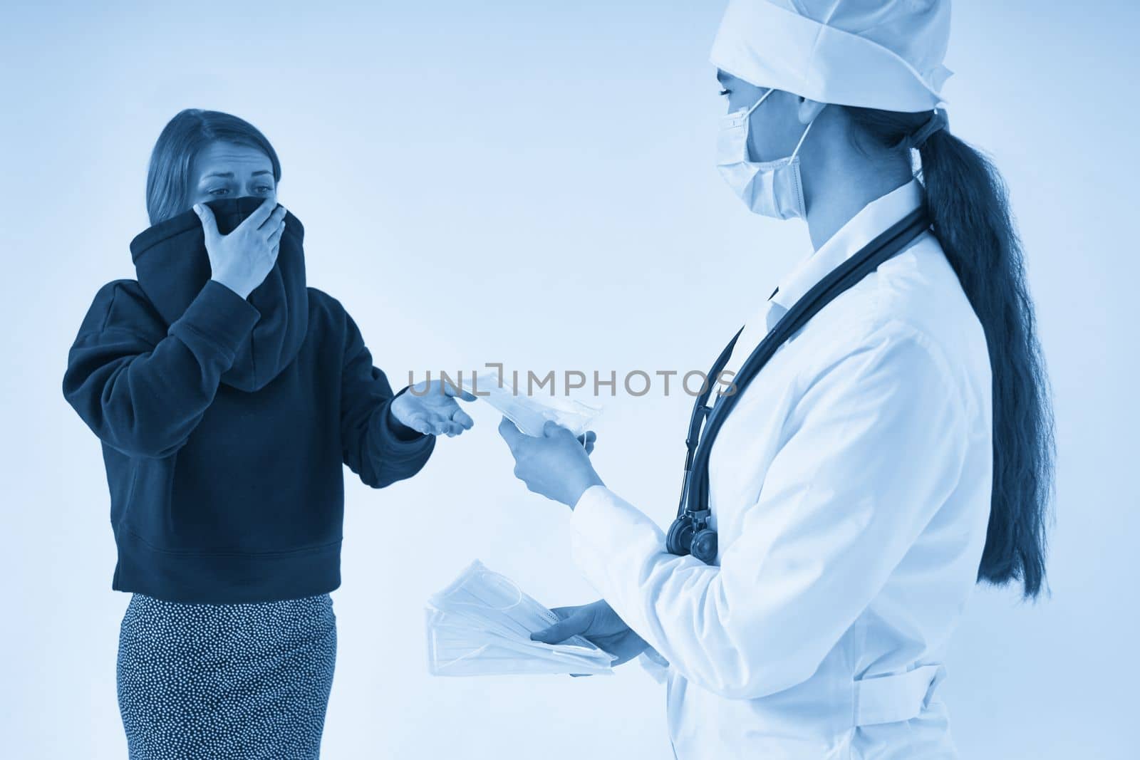 Doctor giving a patient protective face mask to protect from virus infection, coronavirus concept by Mariakray