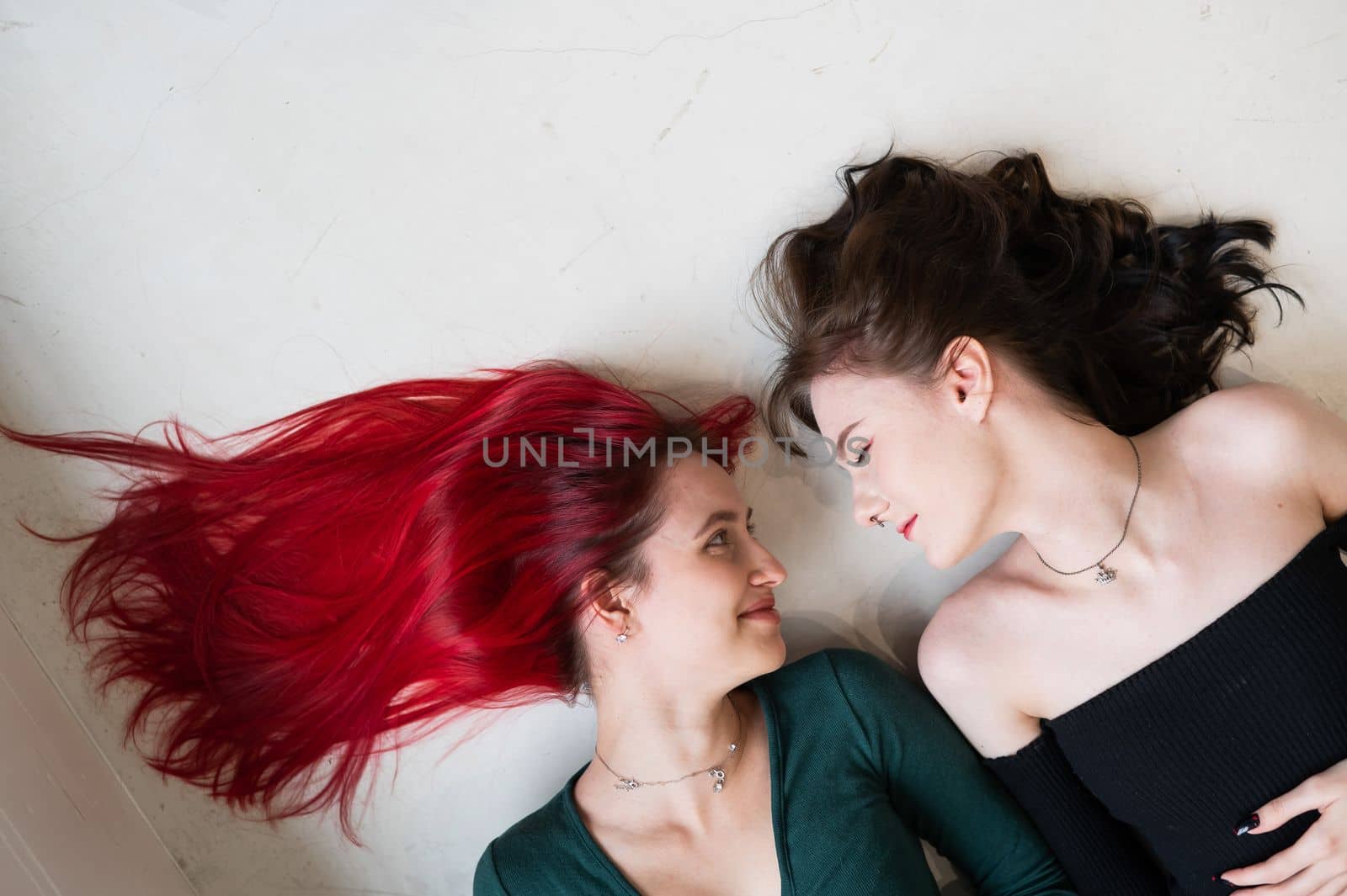 Top view of two women lying side by side. Lesbian intimacy