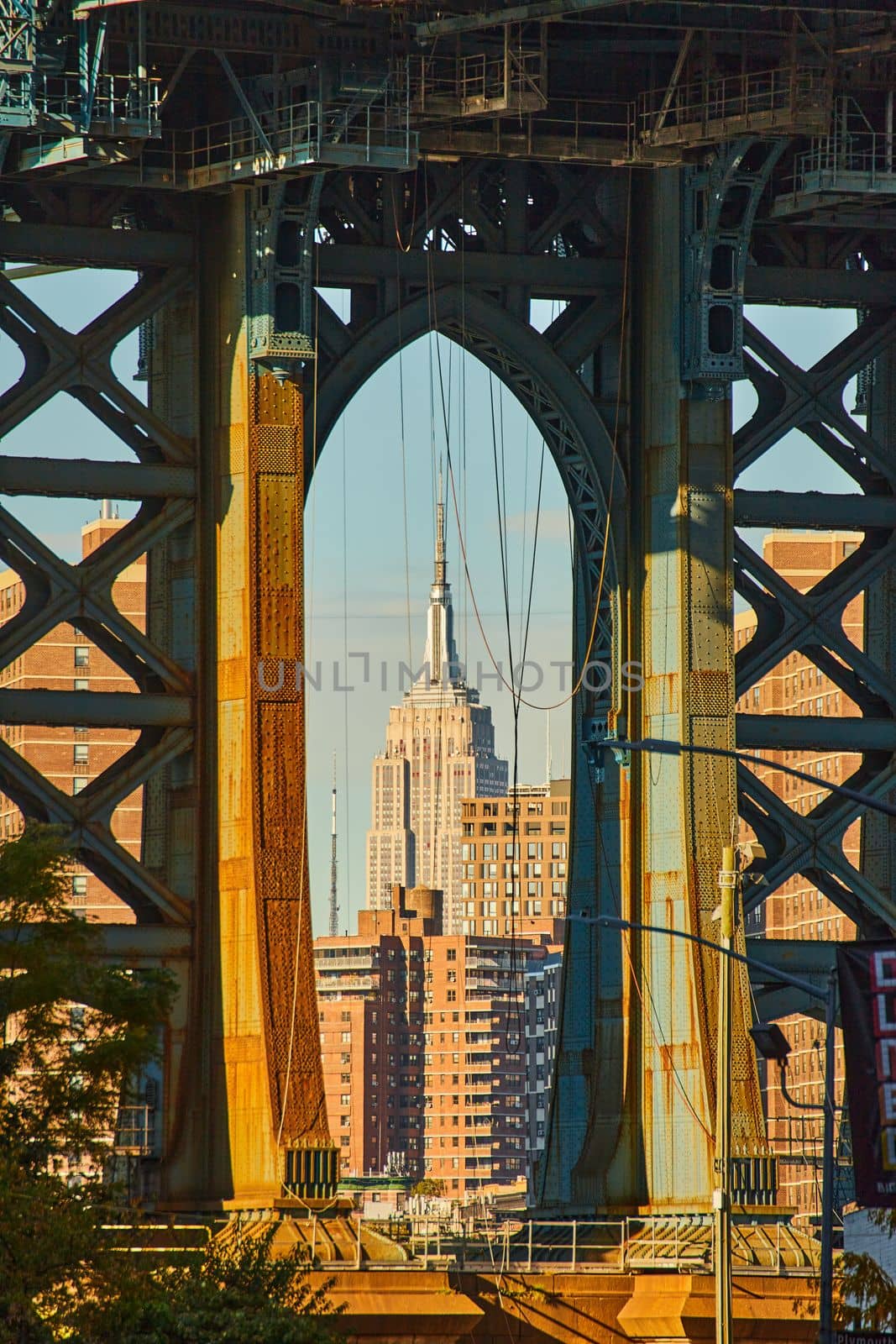 Image of View of Empire State Building through underside of Manhattan Bridge in Brooklyn New York City