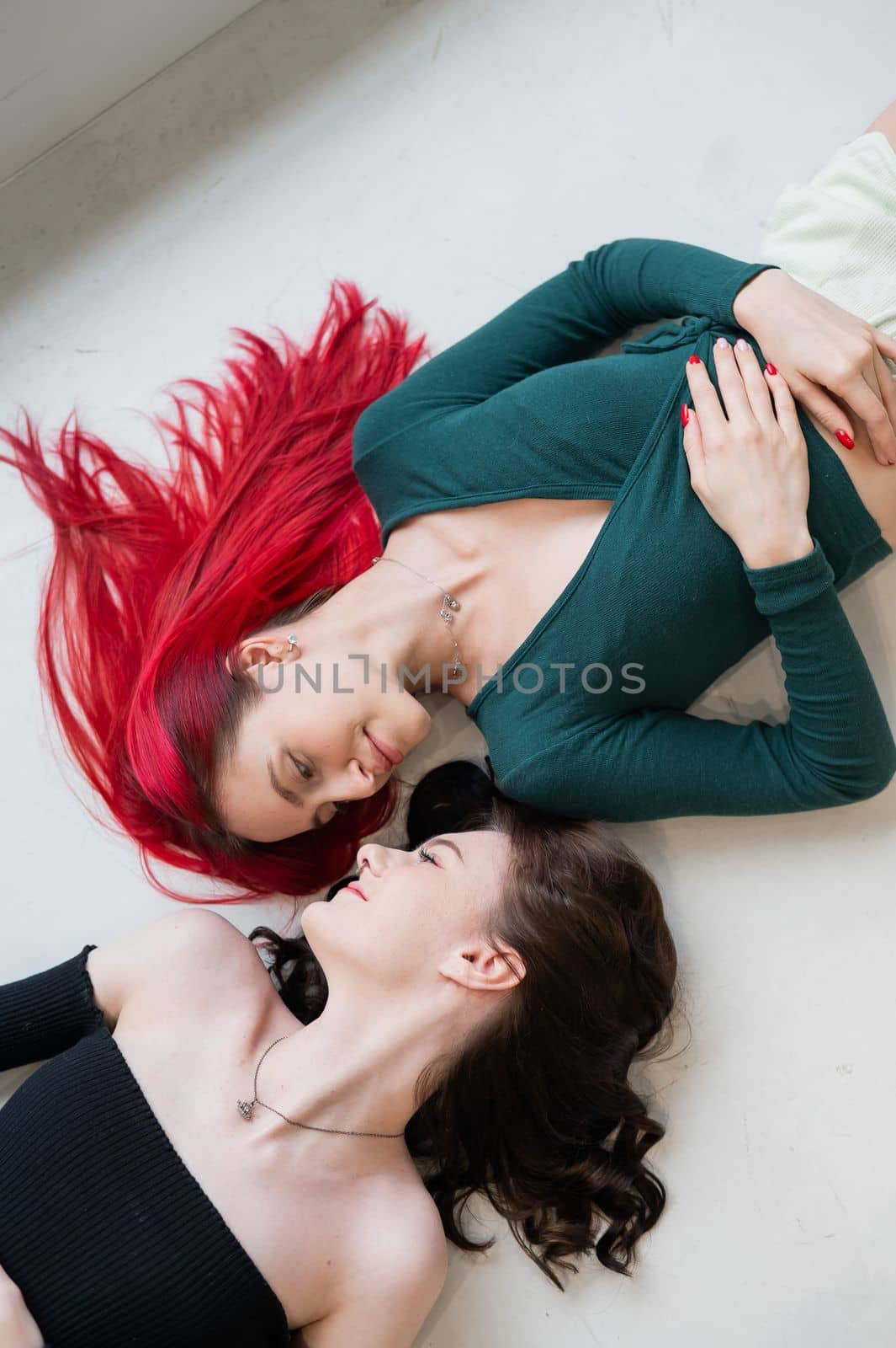 Top view of caucasian women lying and kissing