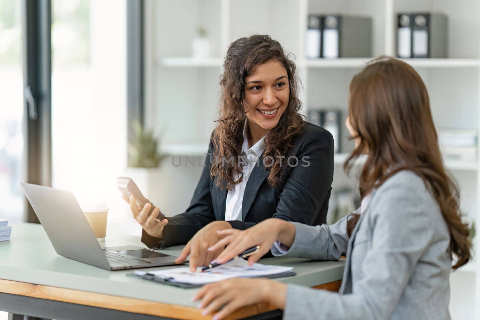 Business People Meeting to discuss and brainstorming the financial report paperwork in home office. Financial advisor teamwork and accounting concept.