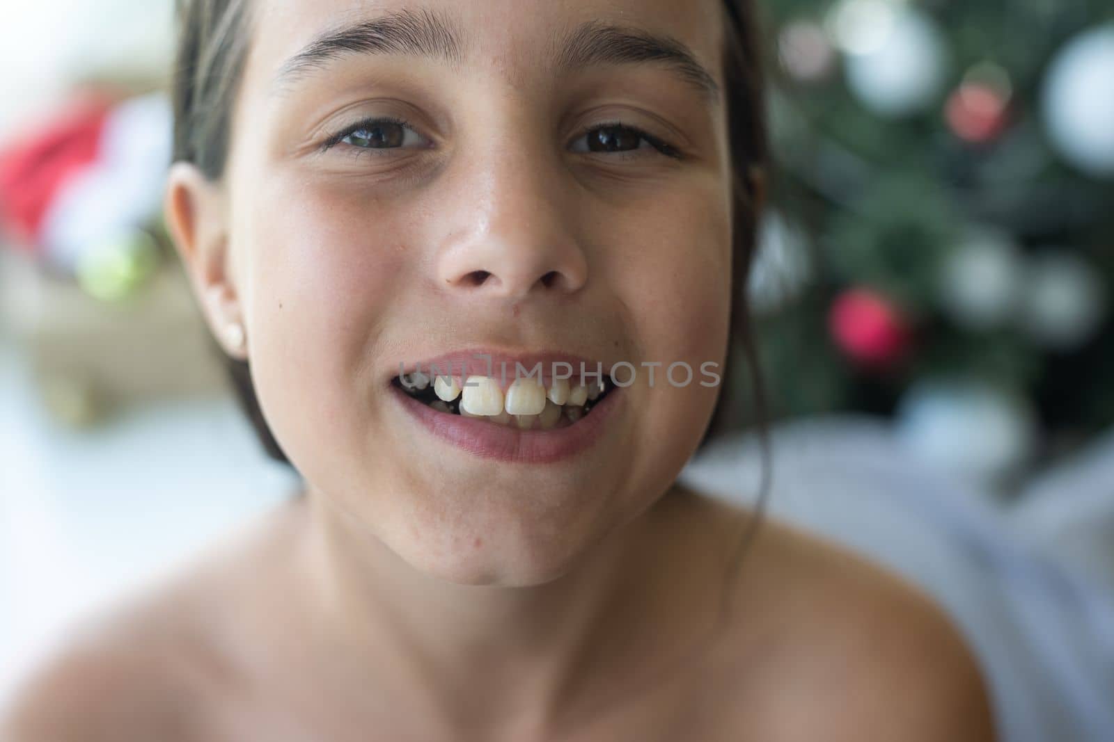 little girl with a plate in her mouth.