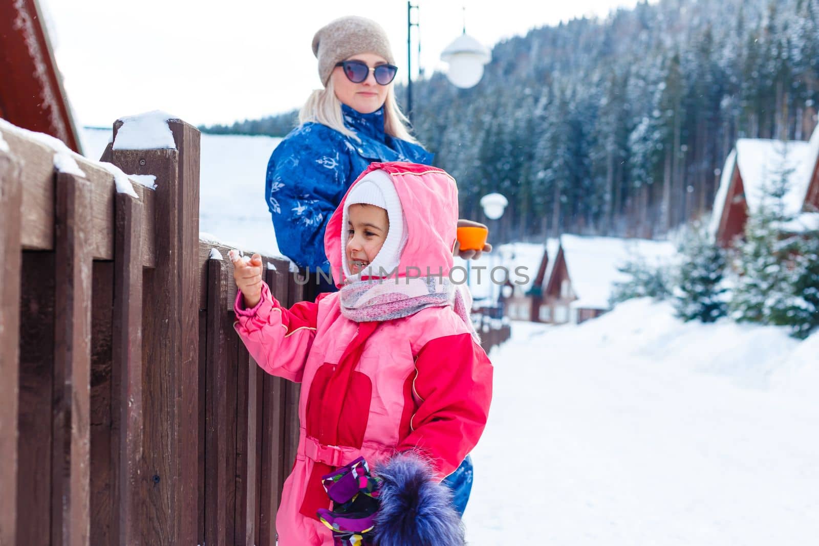 Winter, ski - Little girl with mother in ski resort. by Andelov13