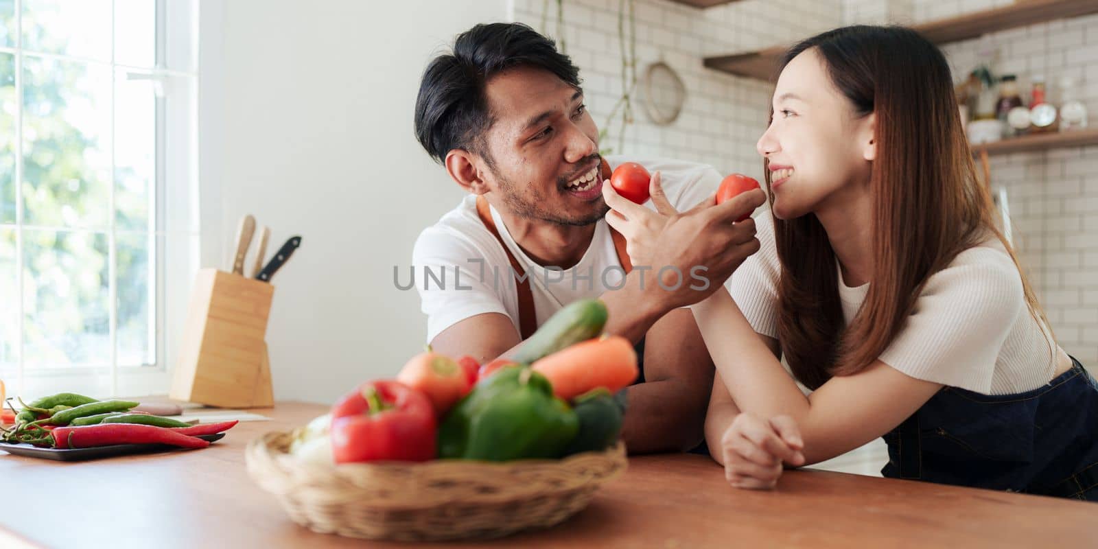Portrait of young asian couple making salad together at home. cooking food and Lifestyle moment and healthy. by itchaznong