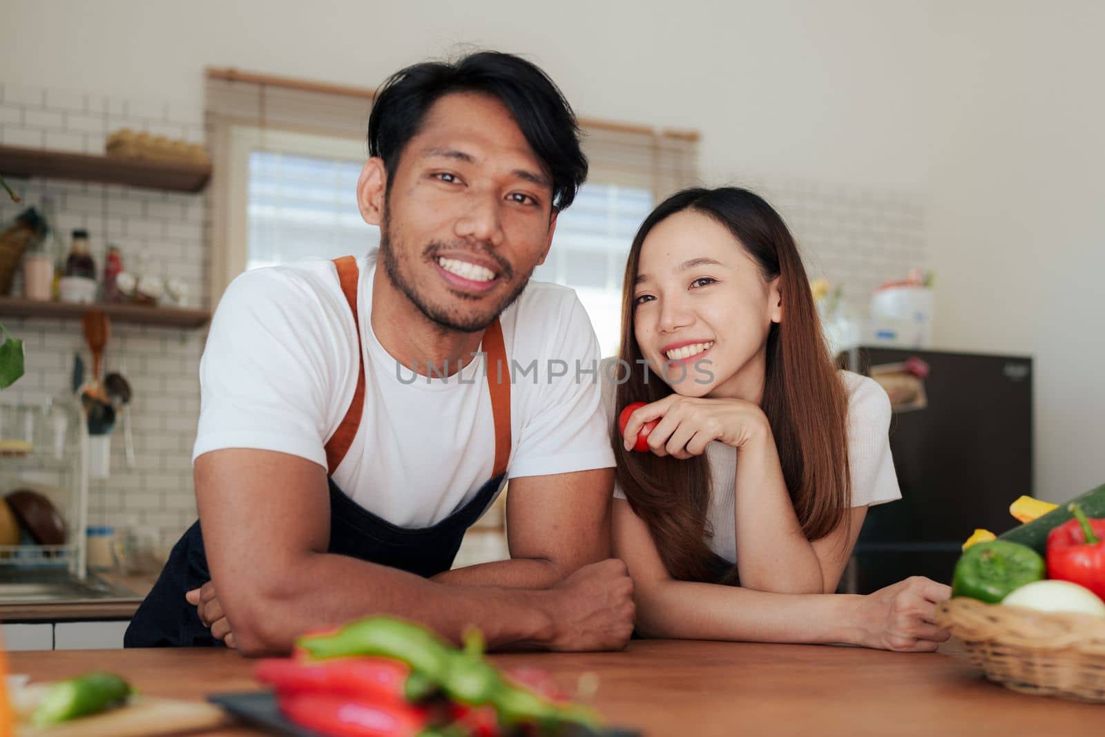 Portrait of young asian couple making salad together at home. cooking food and Lifestyle moment and healthy. by itchaznong
