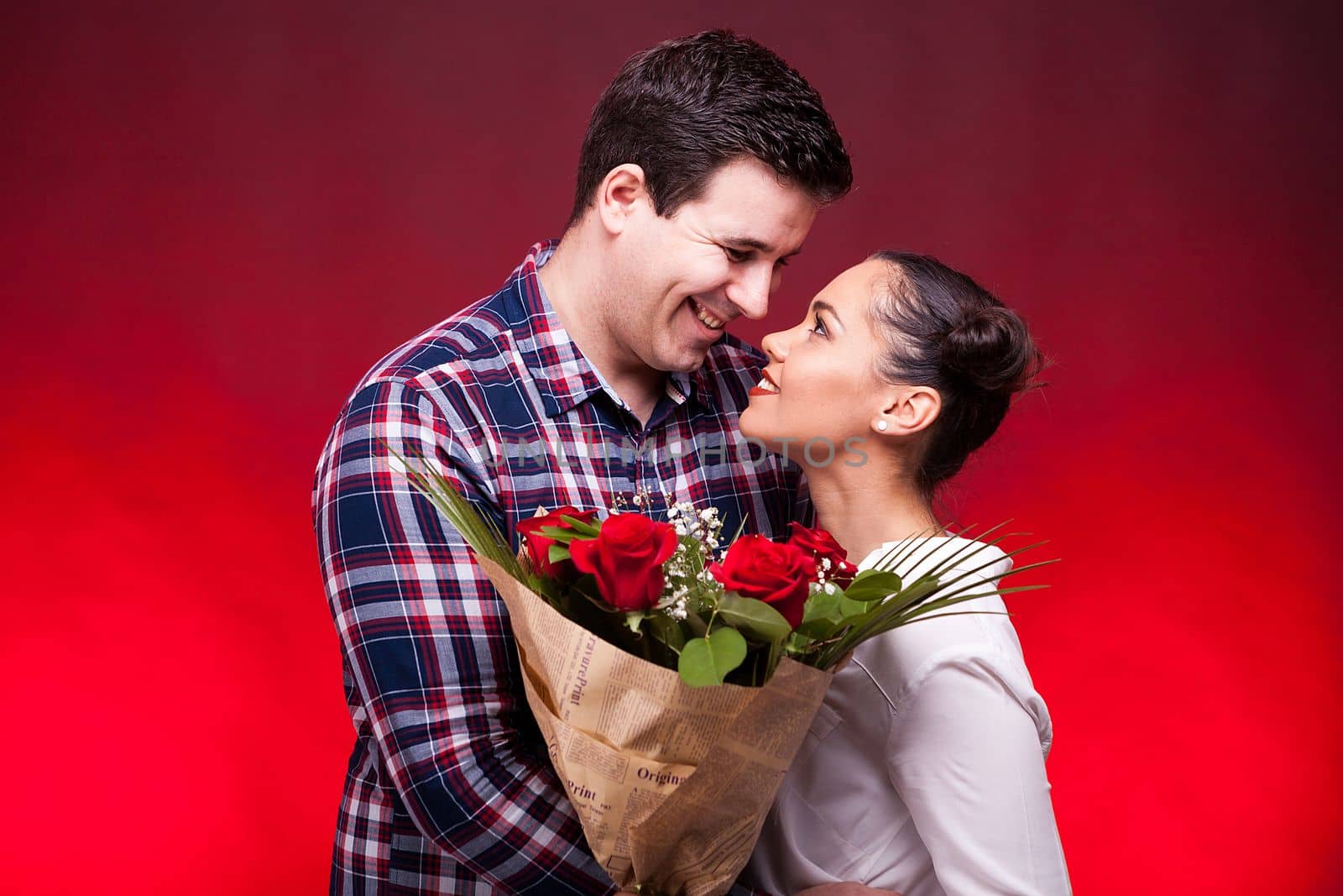 Couple on a date while woman holds flowers in hands by DCStudio