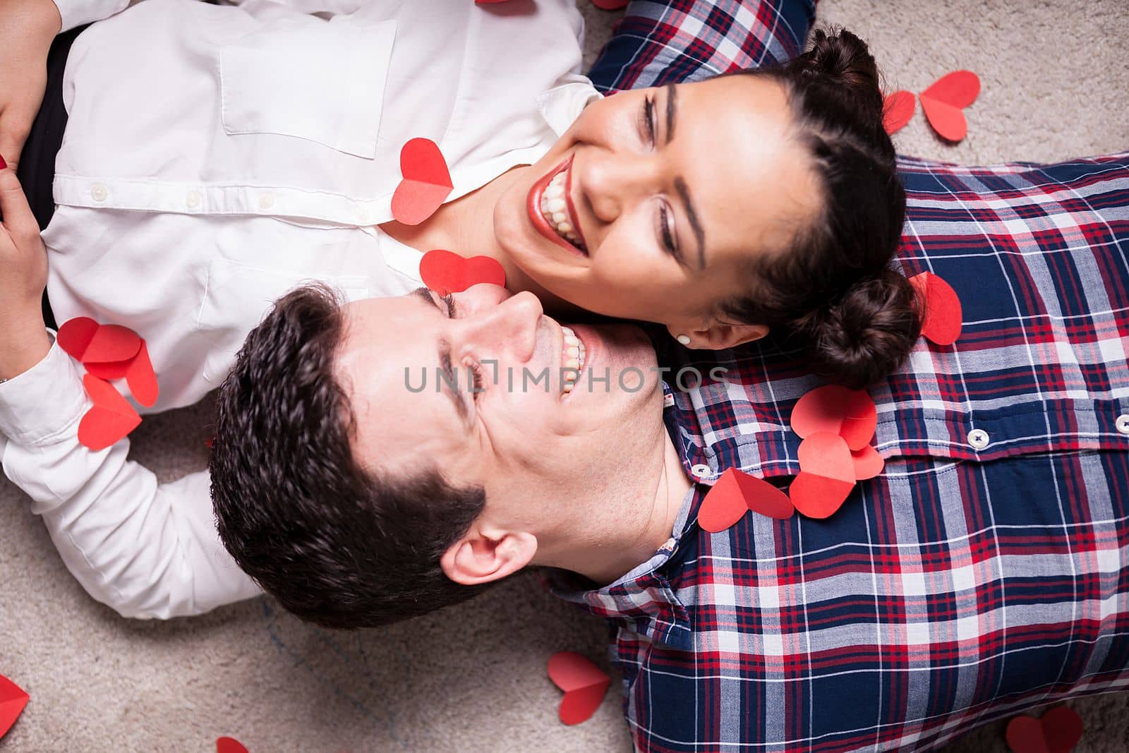 Top close up view on couple lying on the floor by DCStudio