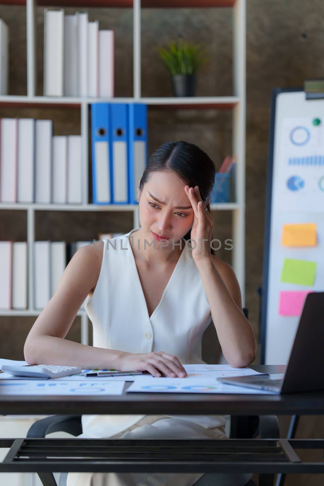 Portrait thoughtful confused young asian businesswoman looking at laptop. Stress while reading news, report or email. Online problem, finance mistake, troubleshooting.