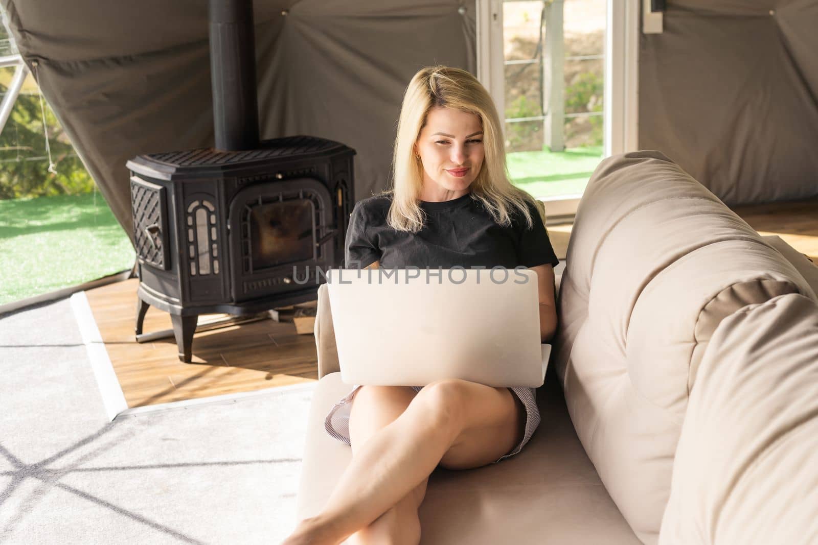 Image of young pleased happy cheerful cute beautiful business woman using laptop computer listening by Andelov13