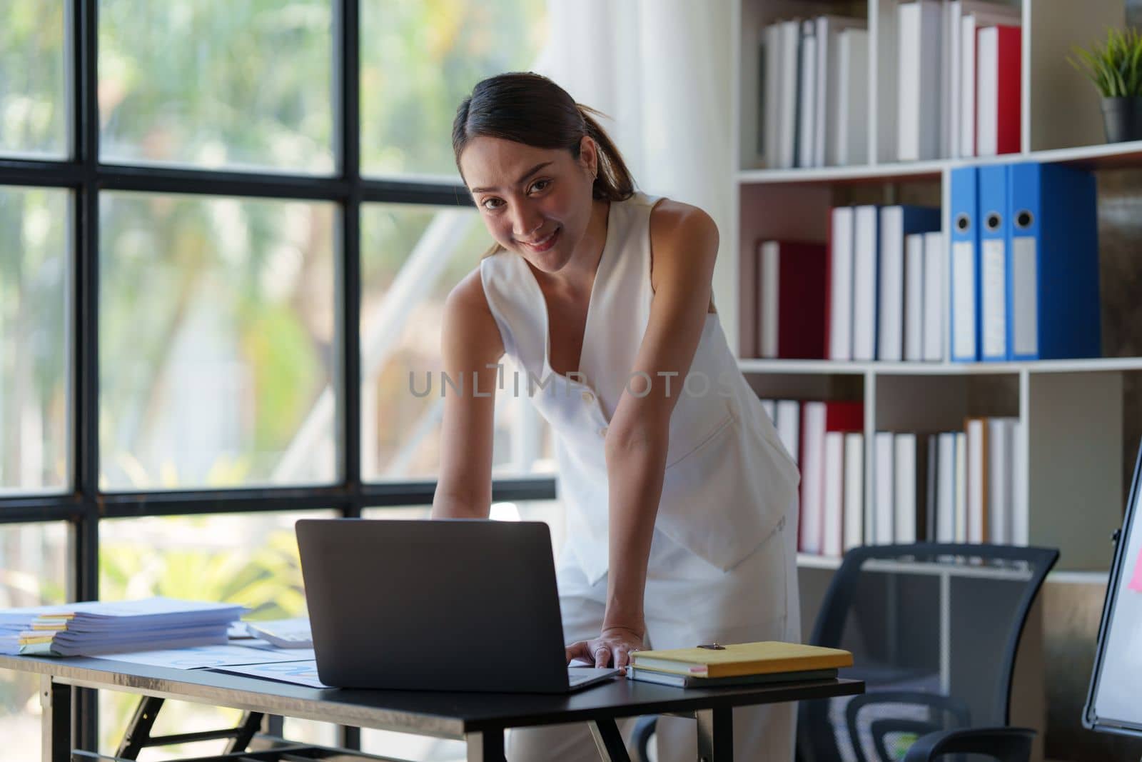 Asian Business woman working at home office and analyze financial report document. Accounting and Finance concept by itchaznong