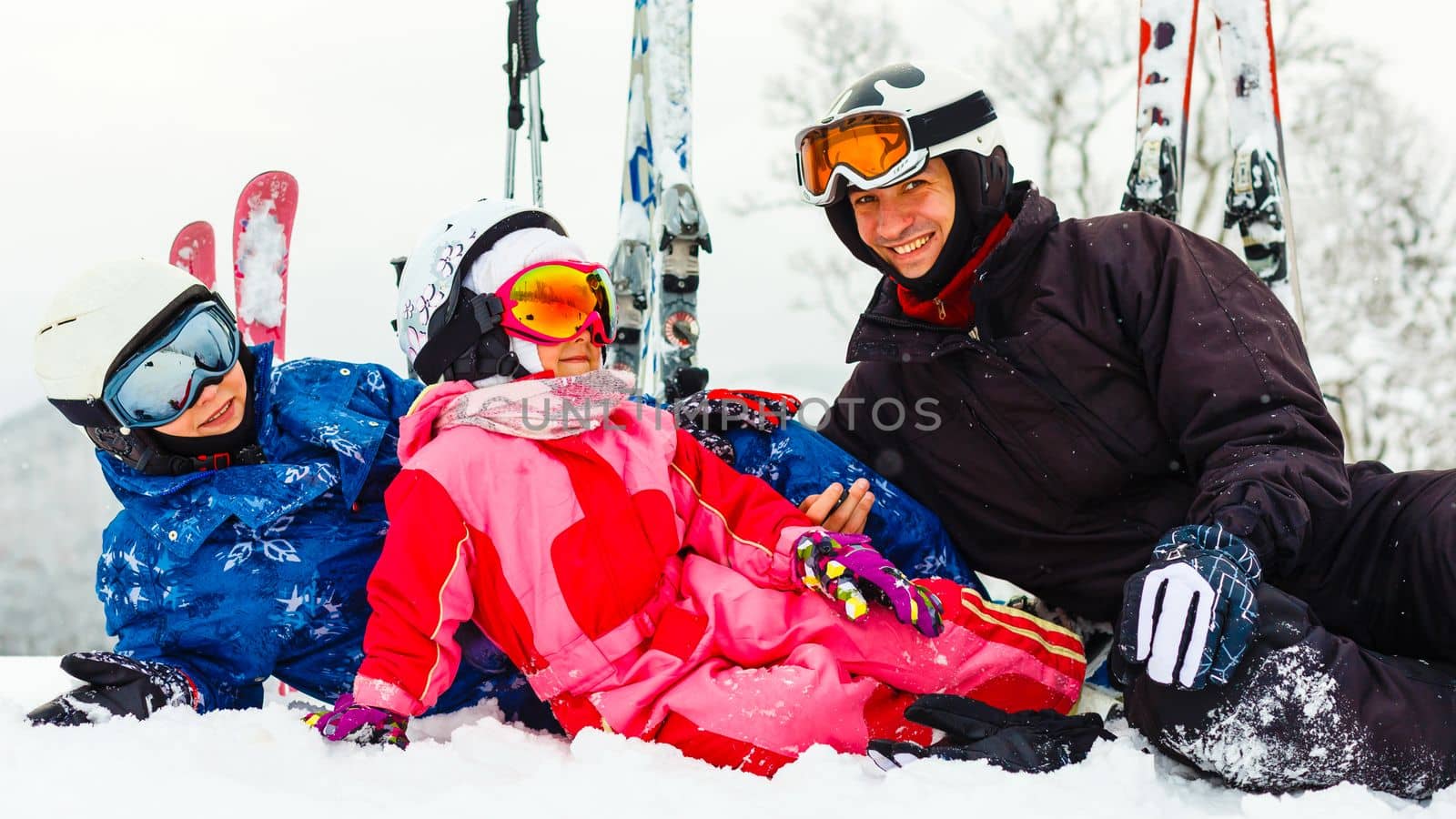 Image of sporty family spending time on winter resort during vacations by Andelov13