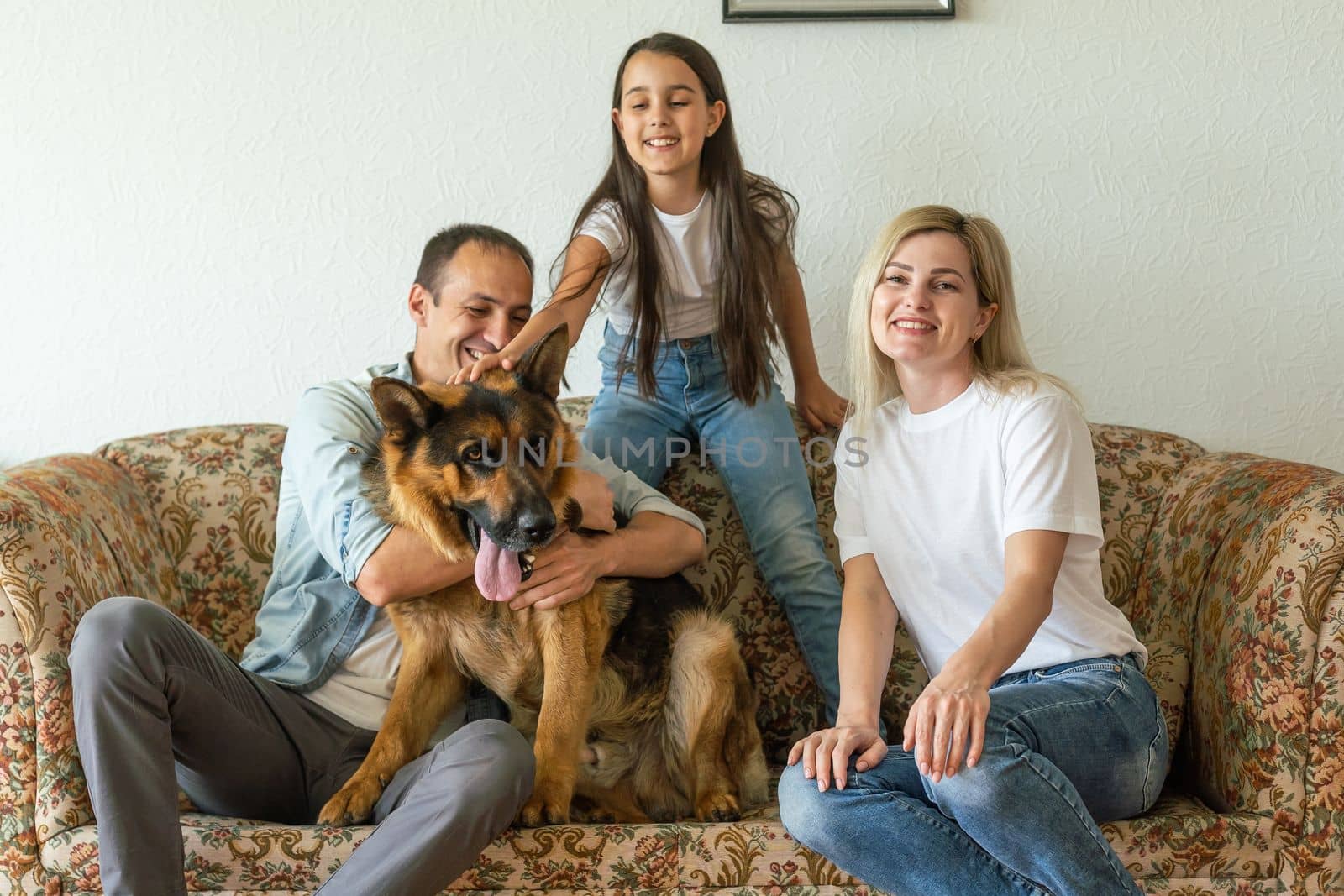 Portrait of happy family with a dog having fun together at home.