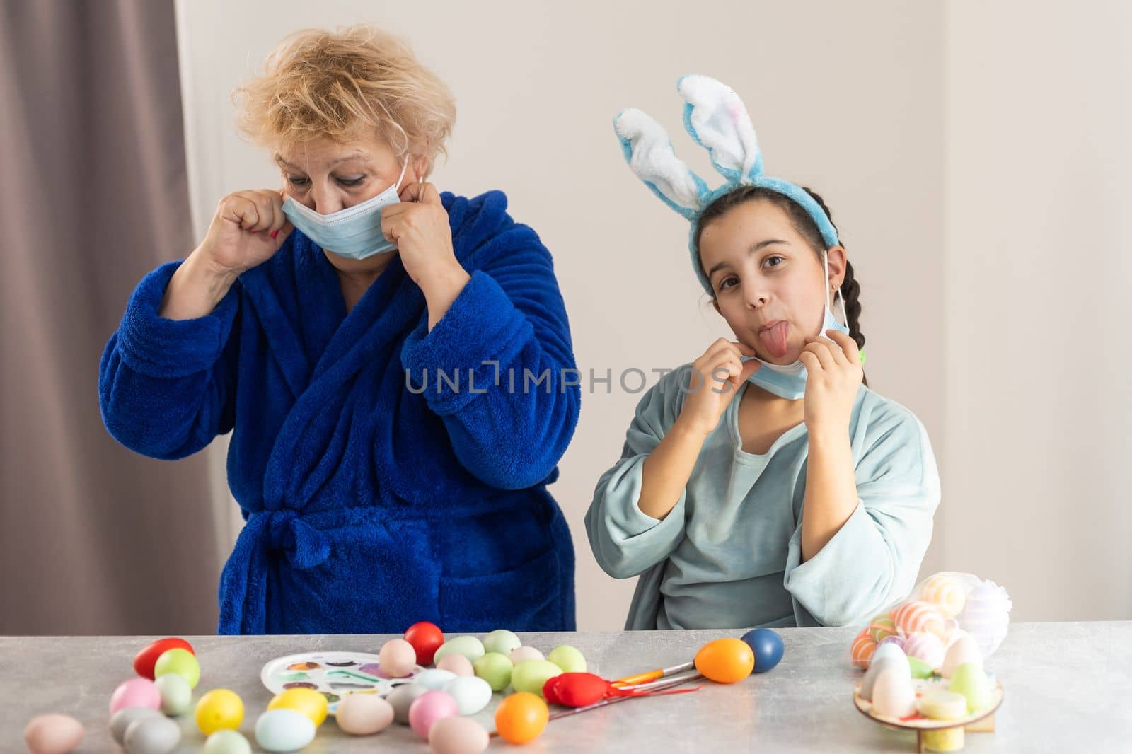 grandmother and granddaughter in masks for easter.